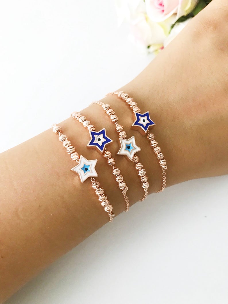 Evil Eye Star Bracelet featuring a rose gold bead chain with blue evil eye and star charm, handmade and adjustable.