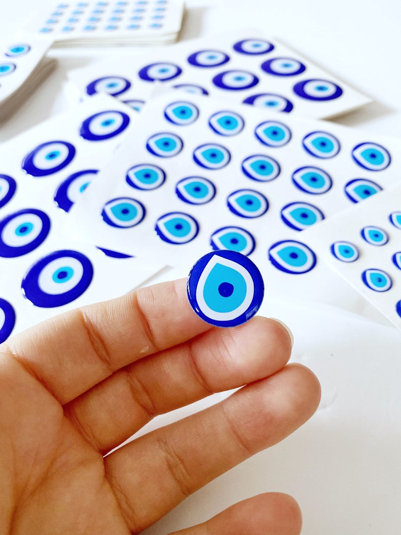 Evil Eye Sticker Pack featuring various sizes of embossed Turkish Evil Eye stickers on a colorful background.