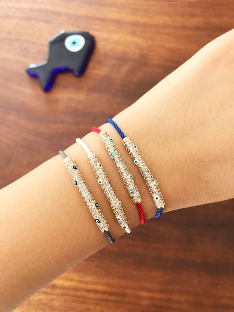 Adjustable Evil Eye Thread Bracelet featuring a zircon charm, available in gray, white, red, and blue colors.