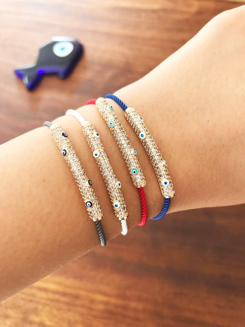 Adjustable Evil Eye Thread Bracelet featuring a zircon charm, available in gray, white, red, and blue colors.