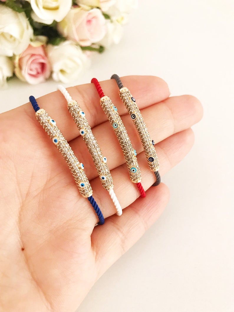 Adjustable Evil Eye Thread Bracelet featuring a zircon charm, available in gray, white, red, and blue colors.