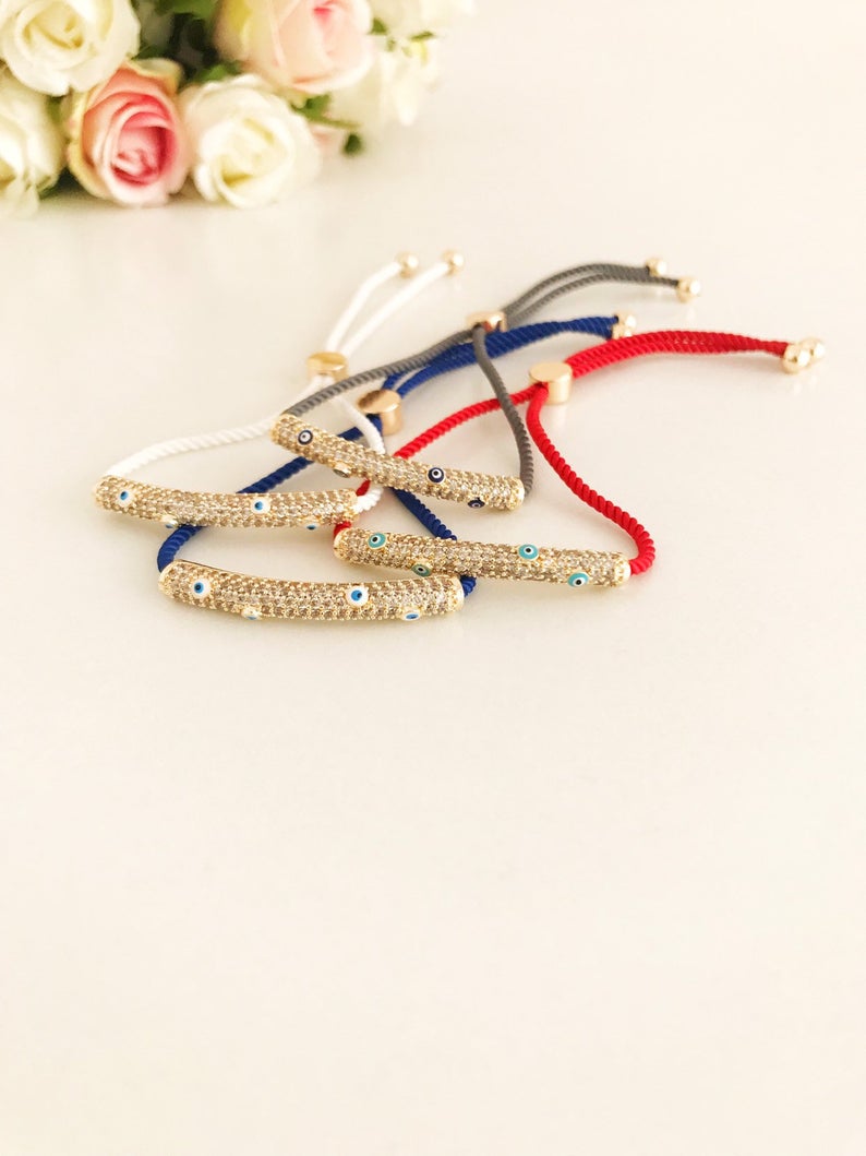 Adjustable Evil Eye Thread Bracelet featuring a zircon charm, available in gray, white, red, and blue colors.