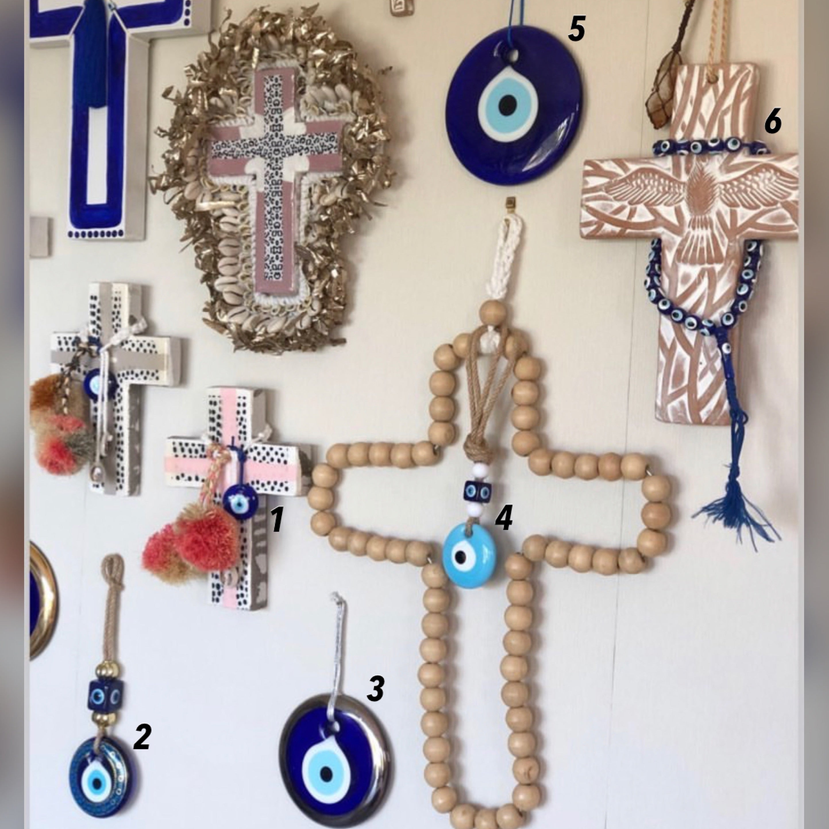 A beautiful blue evil eye wall hanging featuring glass beads, symbolizing protection and good luck, perfect for home decor.