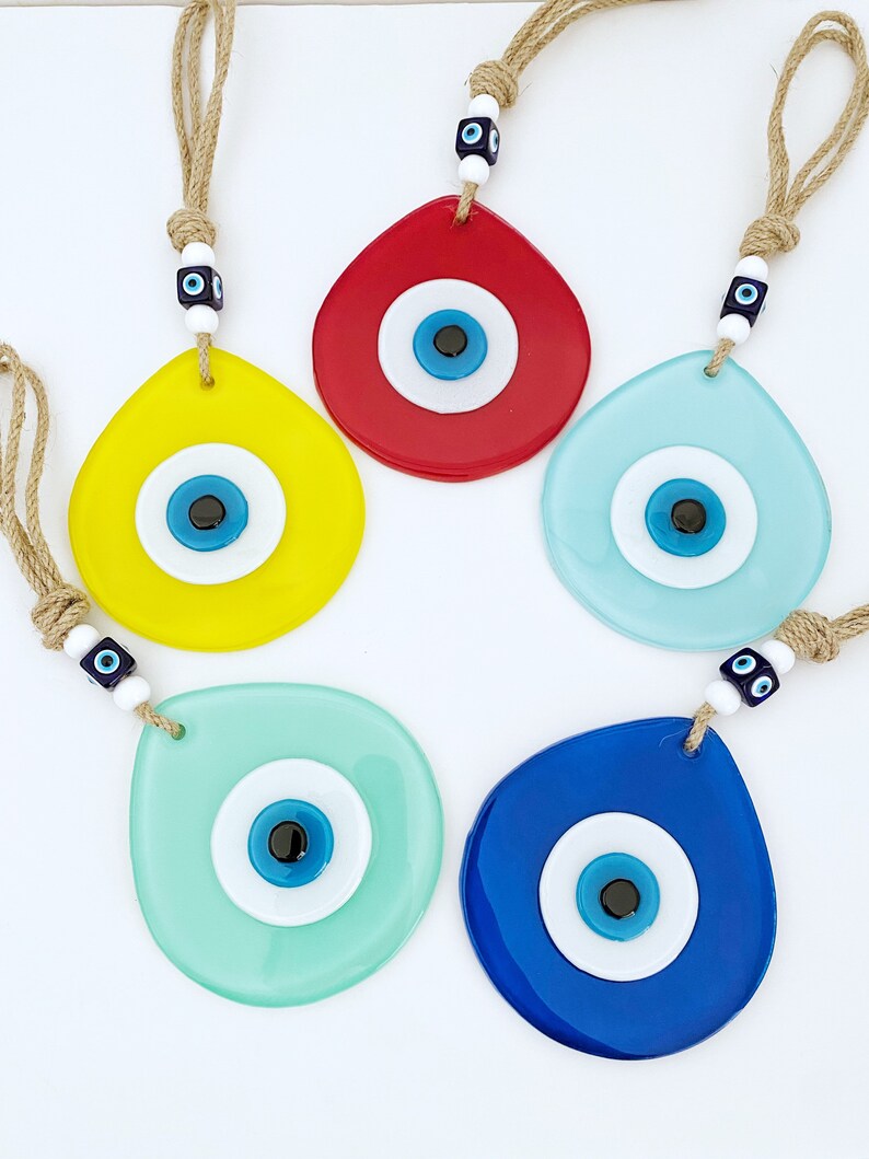 Colorful Evil Eye Wall Hanging made of handmade fused glass, featuring a teardrop design and vibrant colors, symbolizing protection and luck.