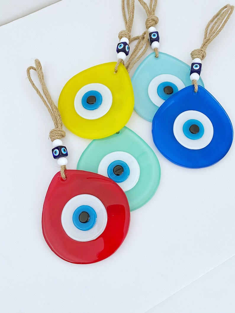 Colorful Evil Eye Wall Hanging made of handmade fused glass, featuring a teardrop design and vibrant colors, symbolizing protection and luck.