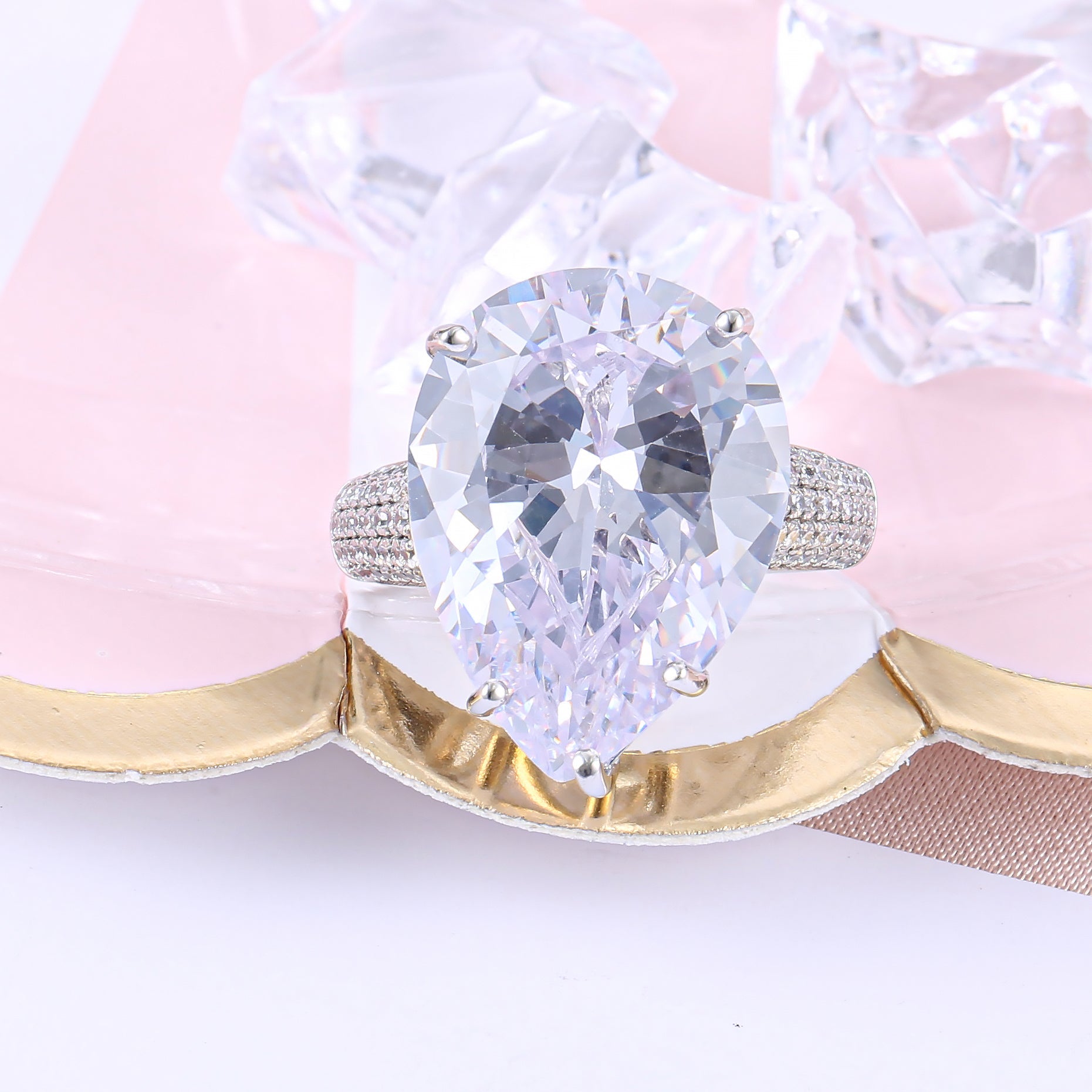 An extraordinary white sapphire engagement ring featuring a pear-shaped stone set in 925 sterling silver with a real white gold finish.