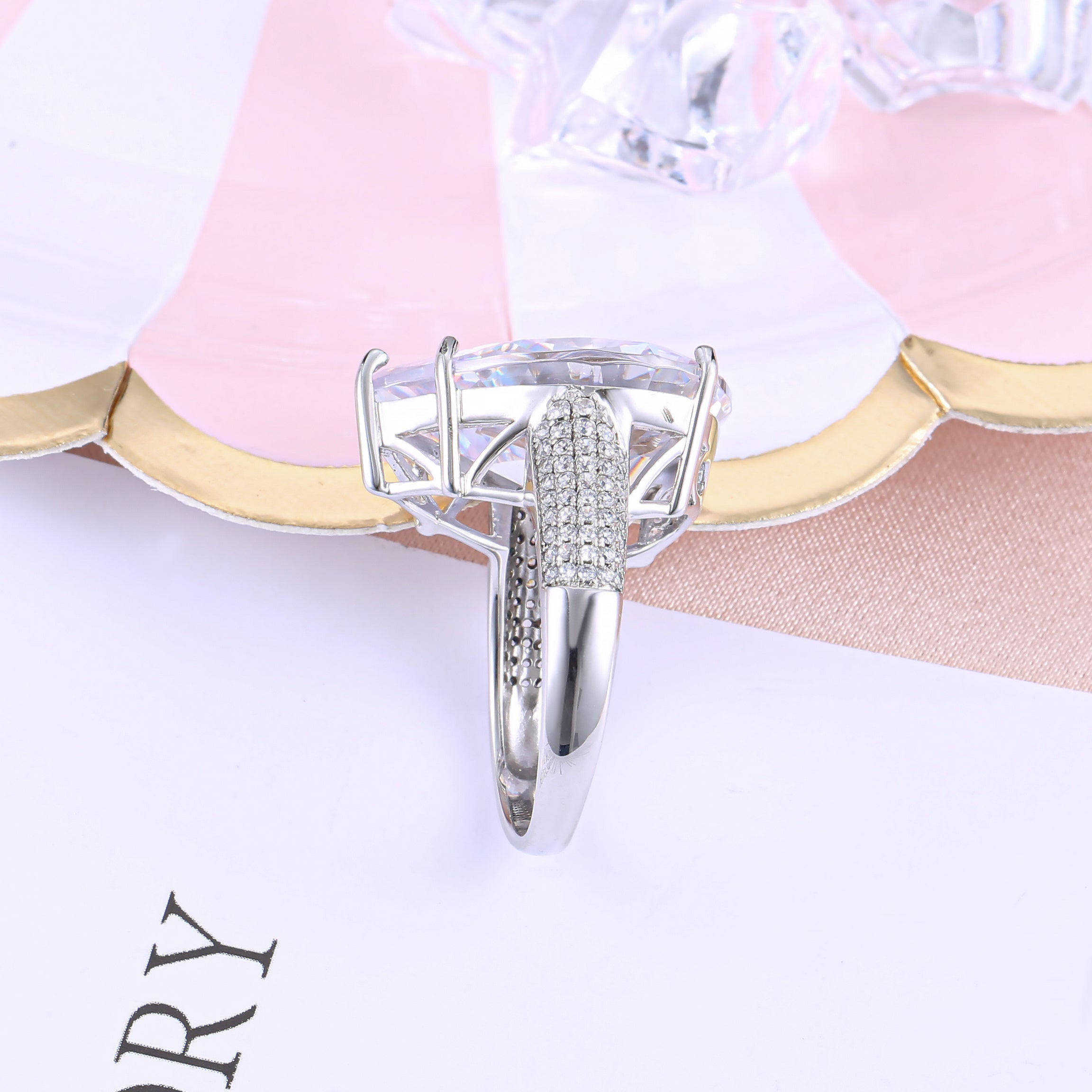 An extraordinary white sapphire engagement ring featuring a pear-shaped stone set in 925 sterling silver with a real white gold finish.