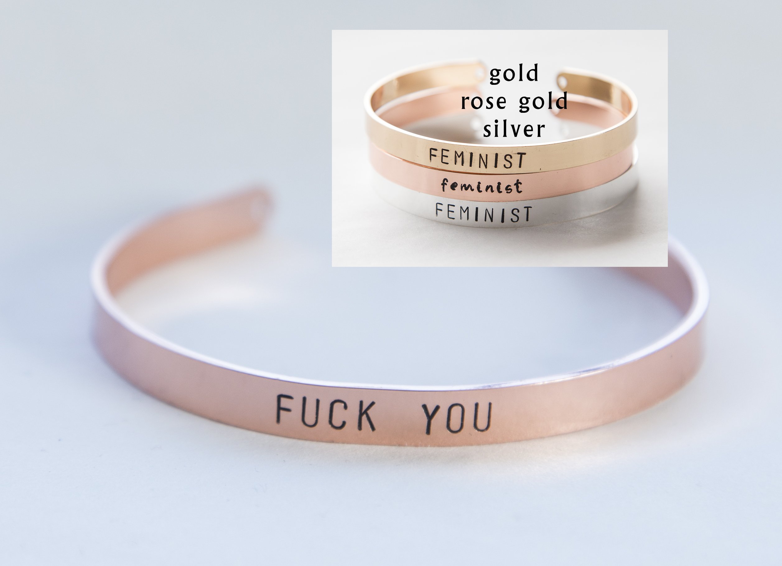 A hand-stamped gold plated cuff bracelet with the phrase 'F off', showcasing its unique design and adjustable size.