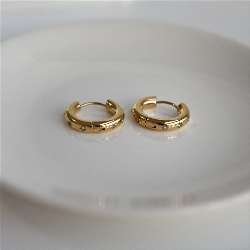 Faith Starburst Round Gold Huggies featuring stardust clear crystals on a polished round design, perfect for everyday wear.