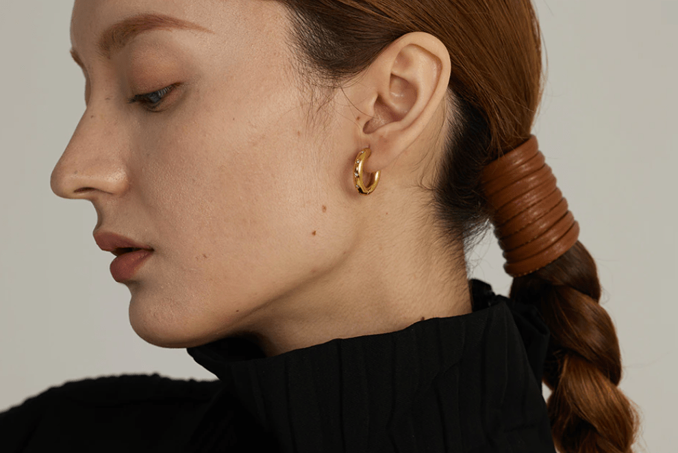 Faith Starburst Round Gold Huggies featuring stardust clear crystals on a polished round design, perfect for everyday wear.