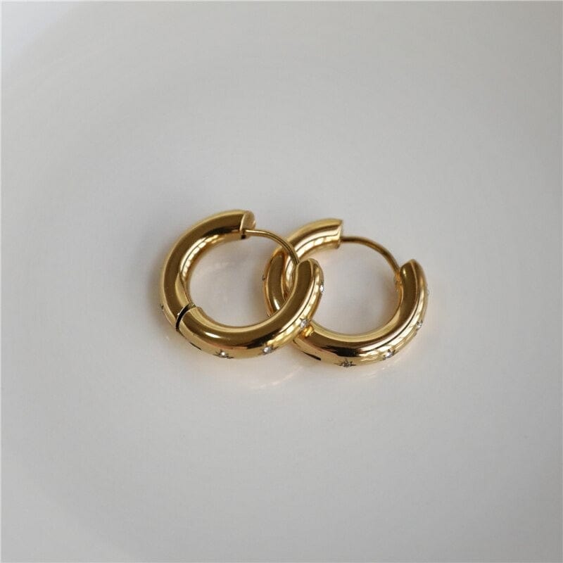 Faith Starburst Round Gold Huggies featuring stardust clear crystals on a polished round design, perfect for everyday wear.