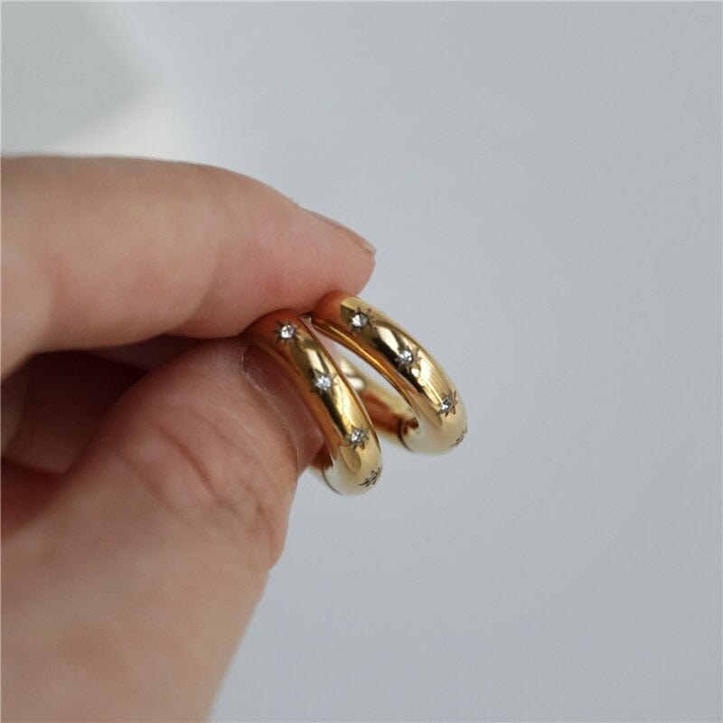 Faith Starburst Round Gold Huggies featuring stardust clear crystals on a polished round design, perfect for everyday wear.