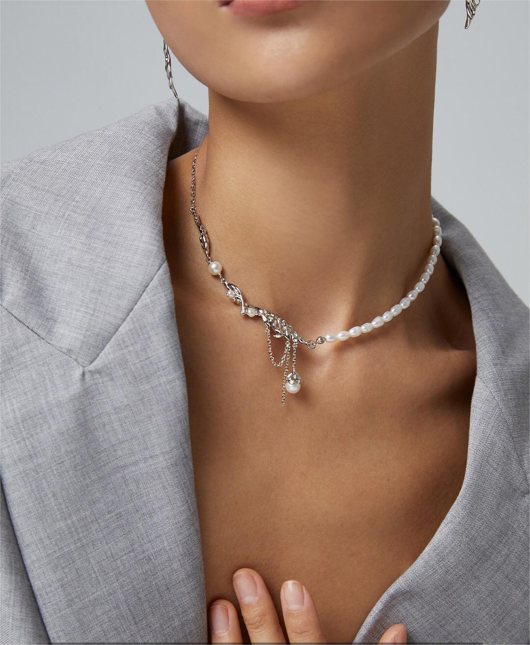 Elegant Feather Style Pearl Pendant Necklace featuring natural pearls and gold vermeil plating, displayed on a soft fabric background.