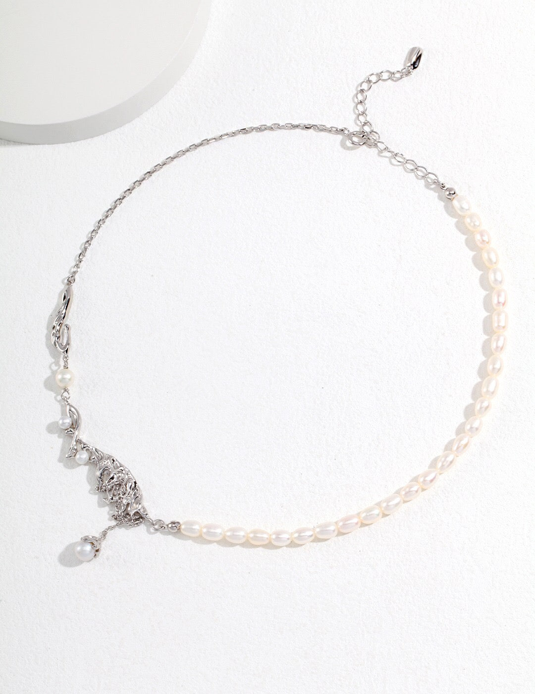 Elegant Feather Style Pearl Pendant Necklace featuring natural pearls and gold vermeil plating, displayed on a soft fabric background.