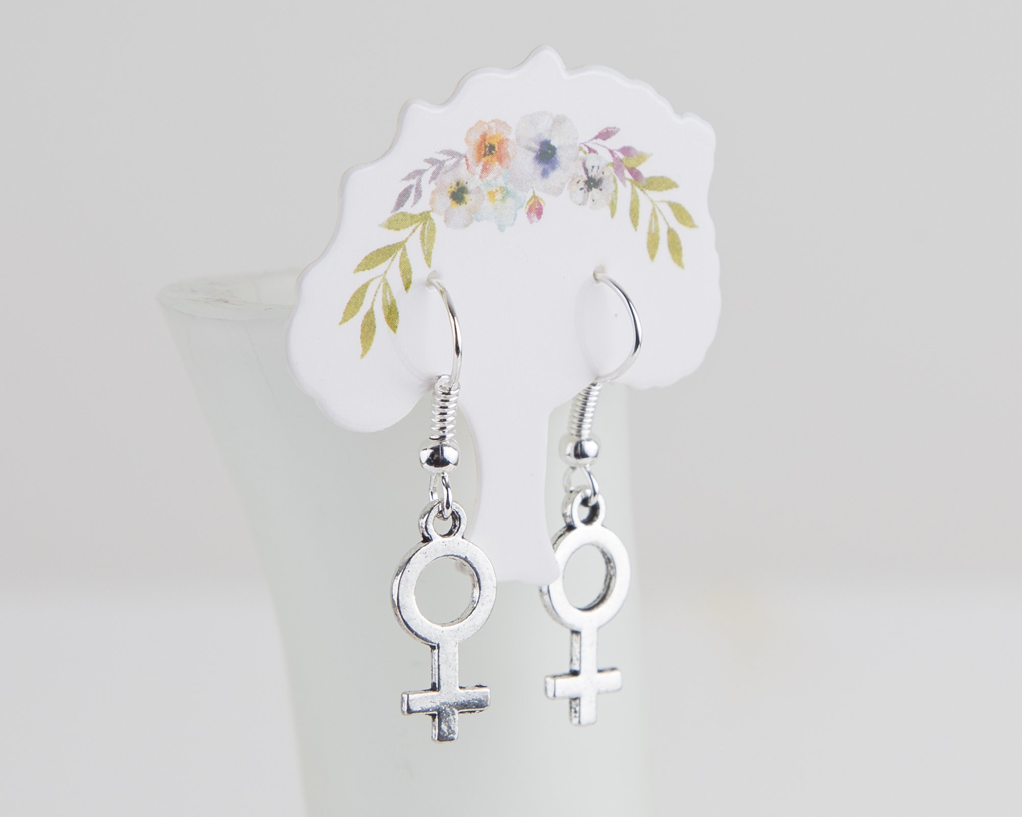 A pair of elegant silver plated female symbol earrings, approximately 3cm long, showcasing a stylish design.