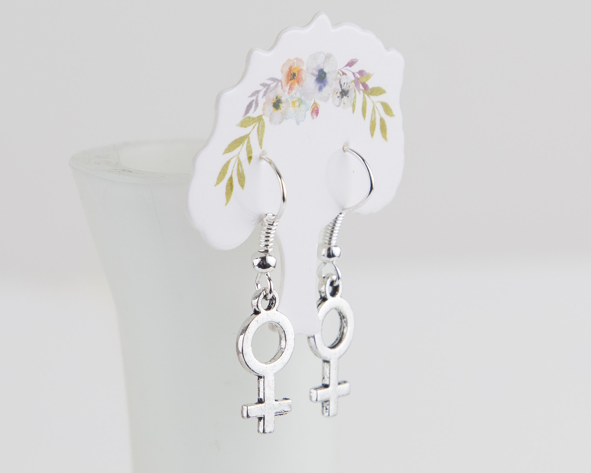 A pair of elegant silver plated female symbol earrings, approximately 3cm long, showcasing a stylish design.