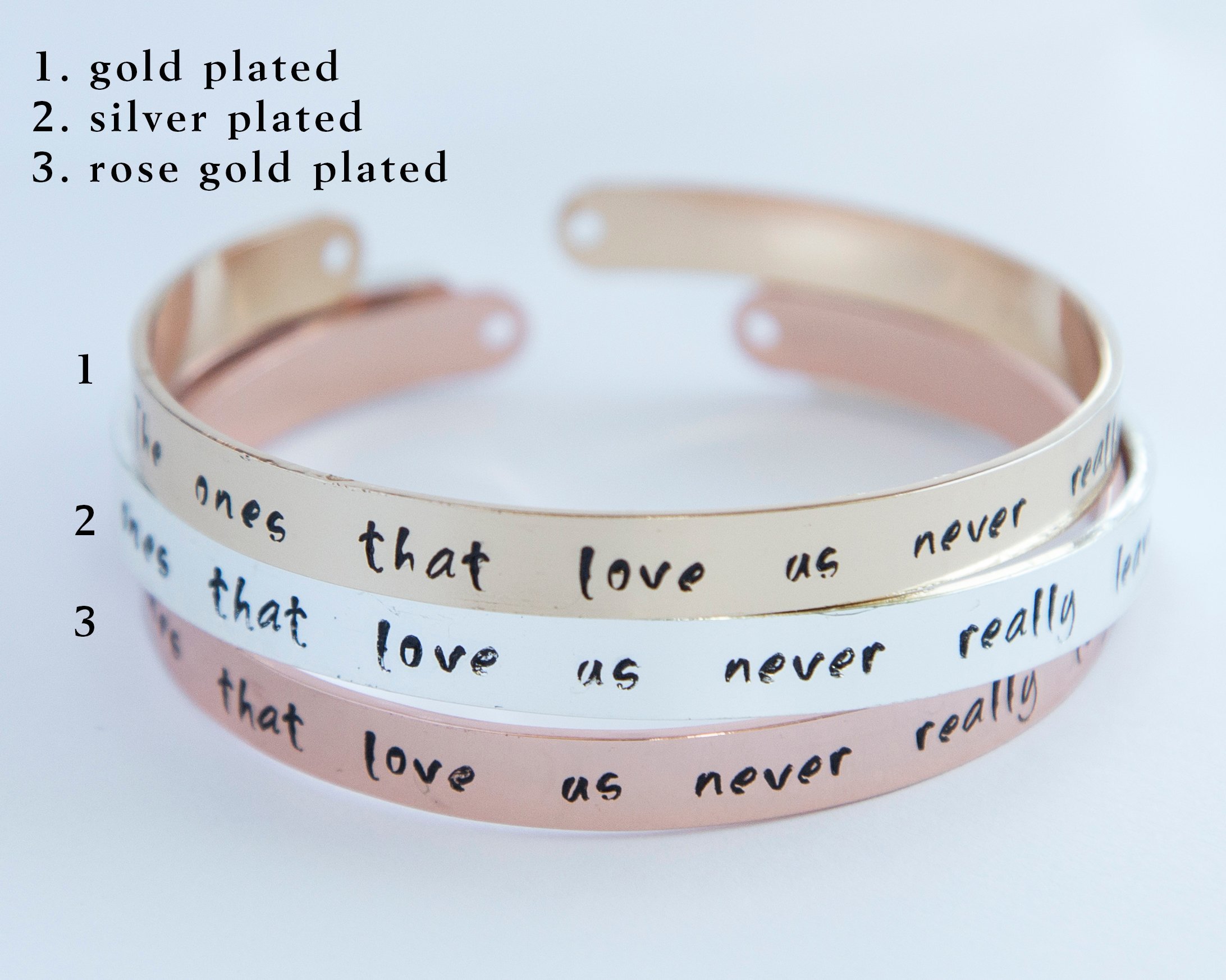 Hand-stamped gold plated cuff bracelet with feminist message, adjustable size, available in rose gold, gold, and silver finishes.