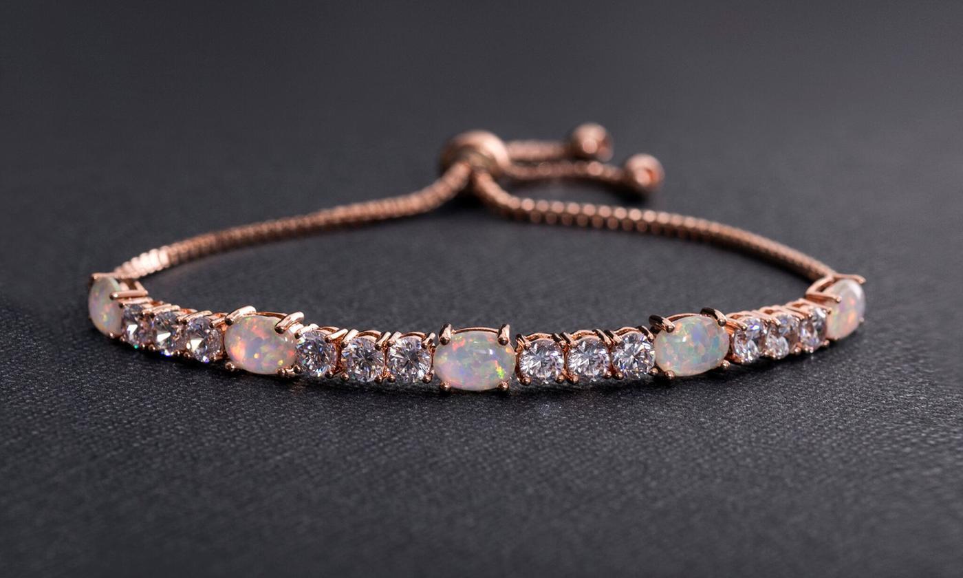 Fiery Opal Tennis Bracelet featuring five opal crystals set in rose gold plating, adjustable length, and a slider lock clasp.