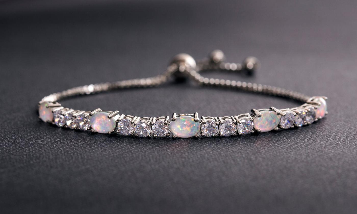 Fiery Opal Tennis Bracelet featuring five opal crystals set in rose gold plating, adjustable length, and a slider lock clasp.