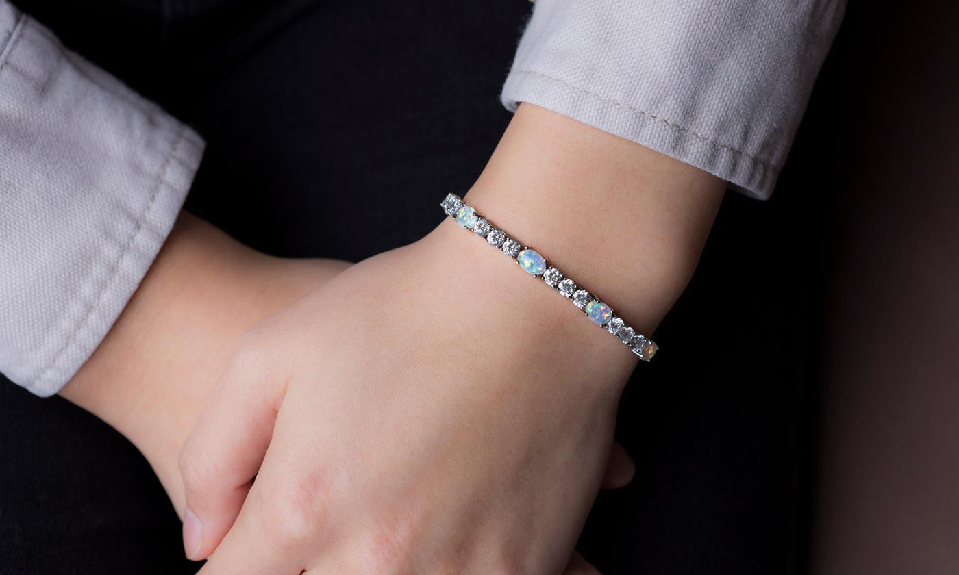 Fiery Opal Tennis Bracelet featuring five opal crystals set in rose gold plating, adjustable length, and a slider lock clasp.