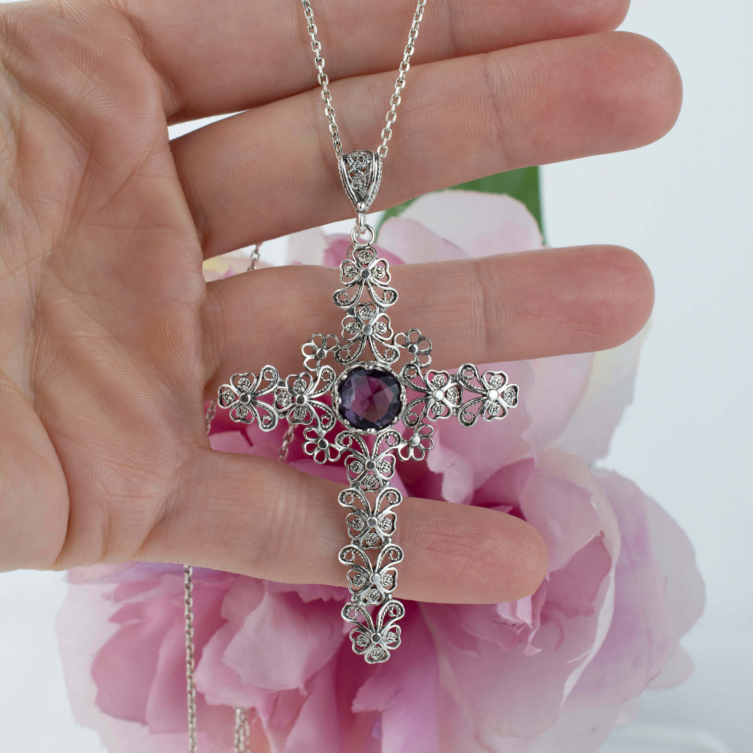 Sterling silver filigree cross pendant featuring a round cut 6mm amethyst gemstone, elegantly designed for women.