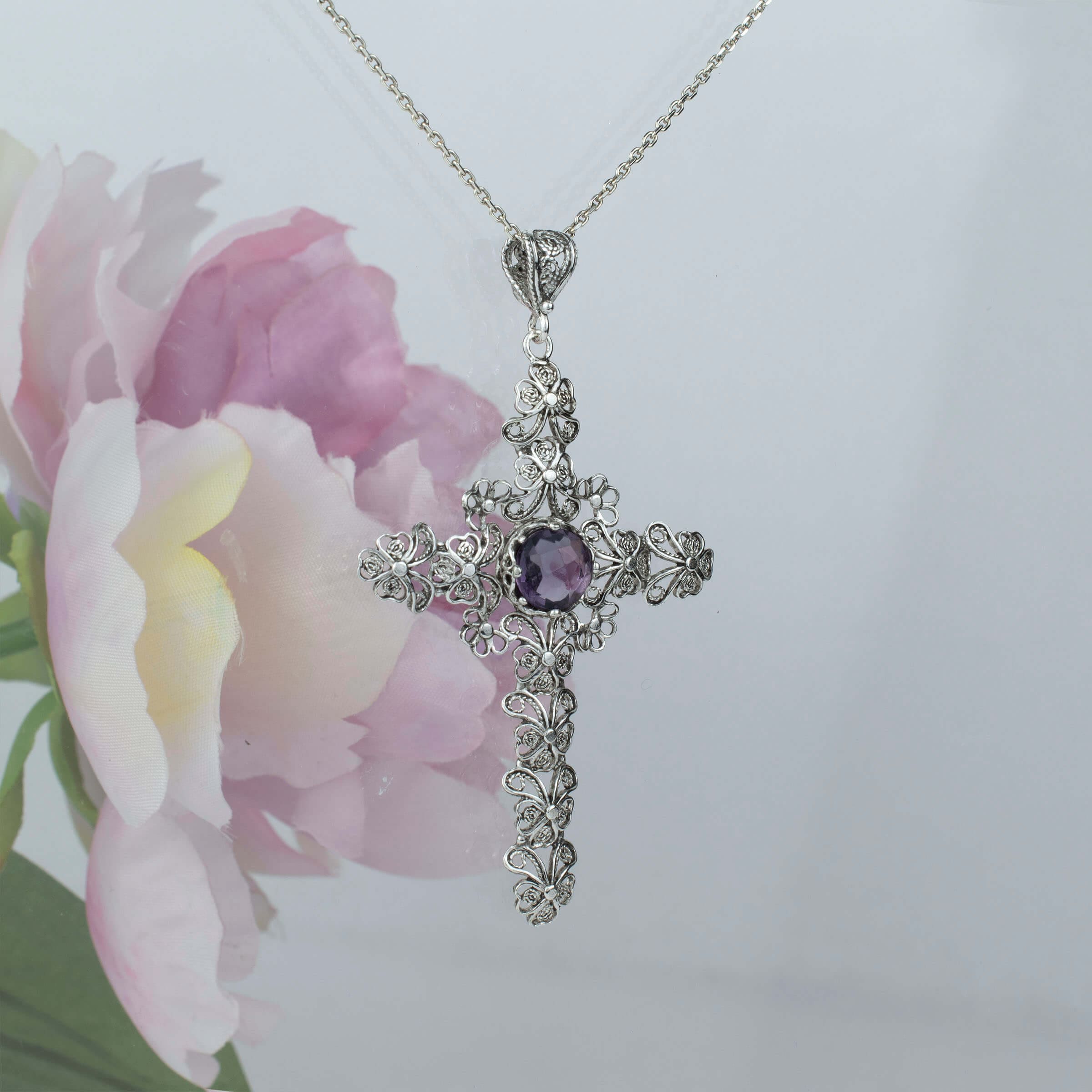 Sterling silver filigree cross pendant featuring a round cut 6mm amethyst gemstone, elegantly designed for women.