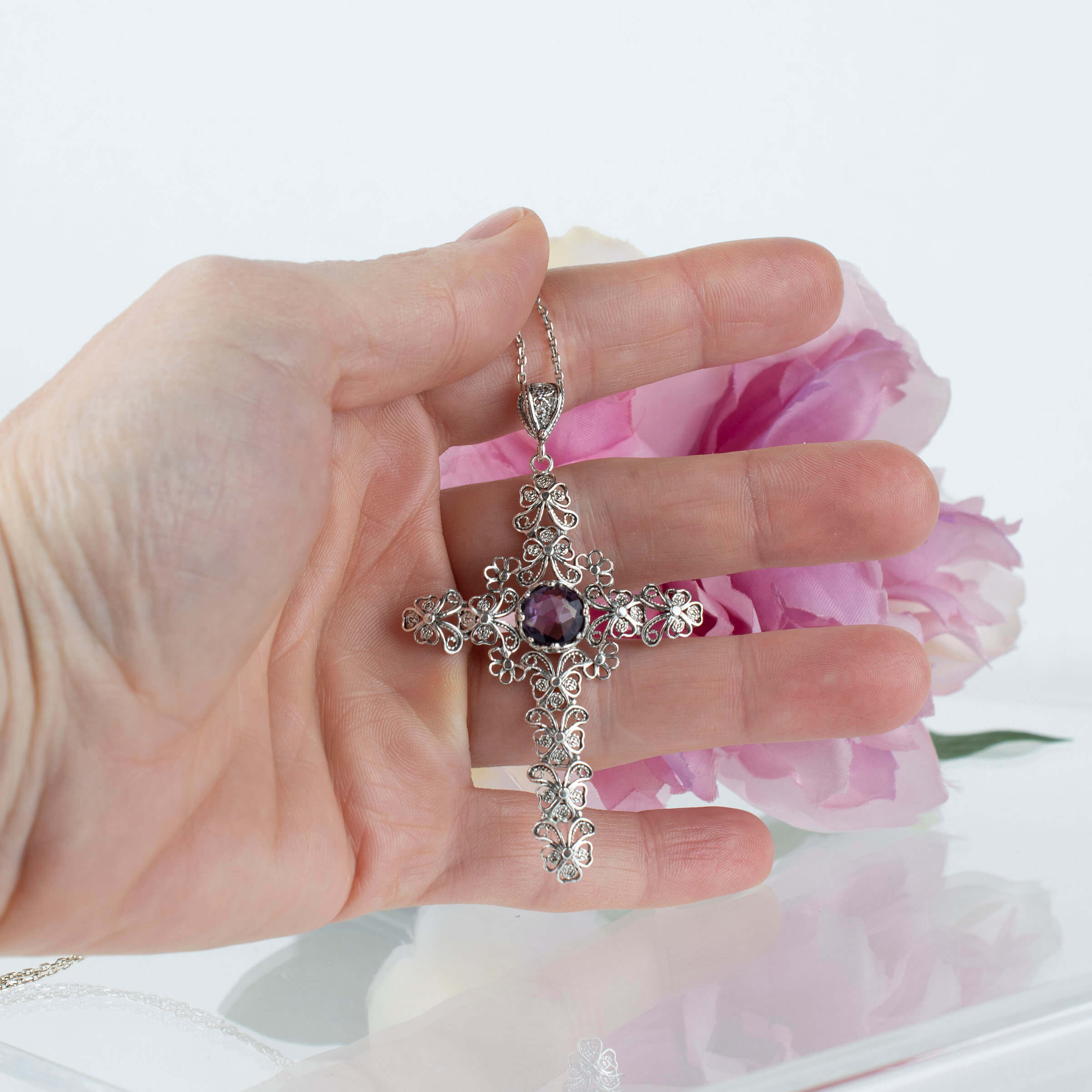 Sterling silver filigree cross pendant featuring a round cut 6mm amethyst gemstone, elegantly designed for women.