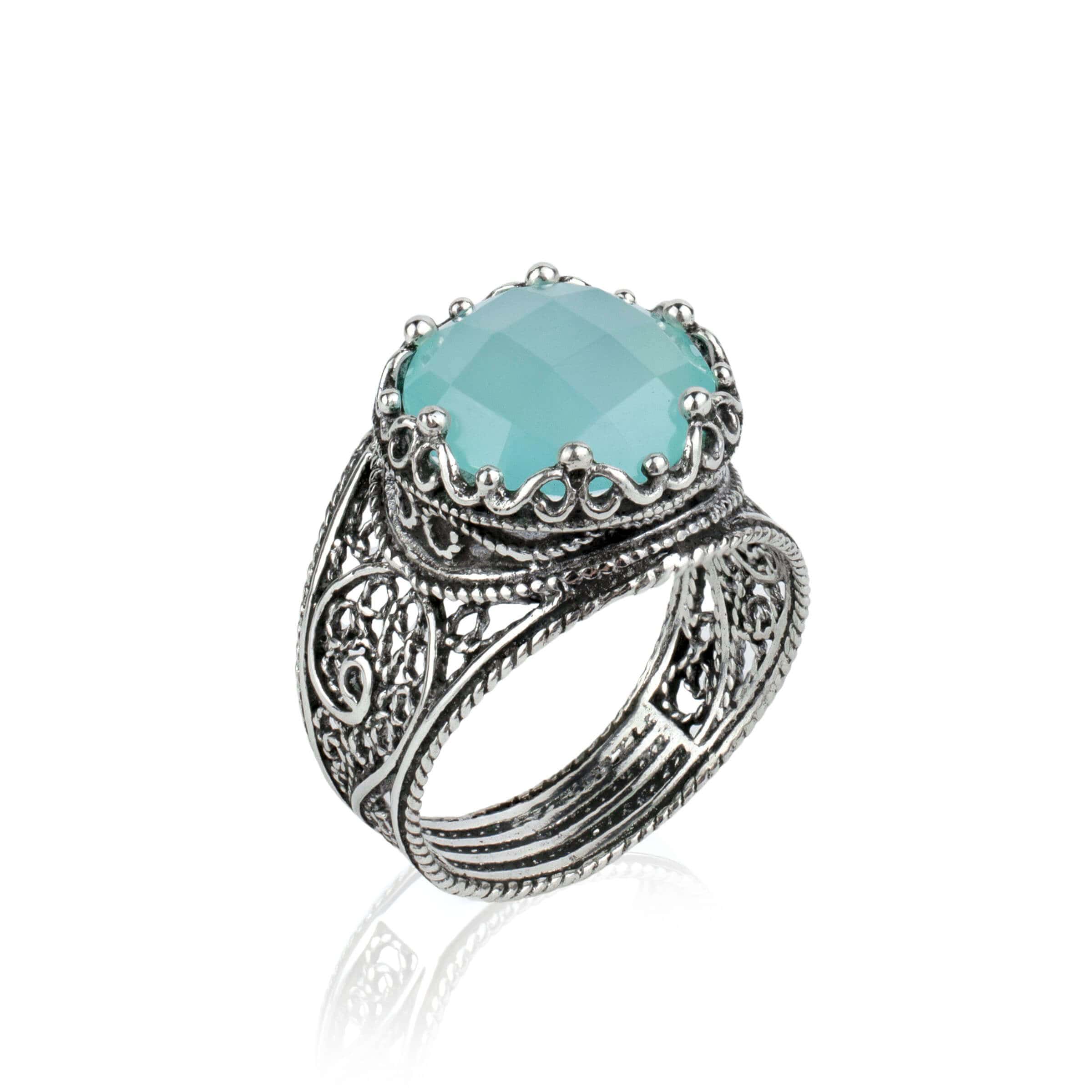 Handmade filigree art ring featuring aqua blue chalcedony gemstone in a crown design, set in polished sterling silver.