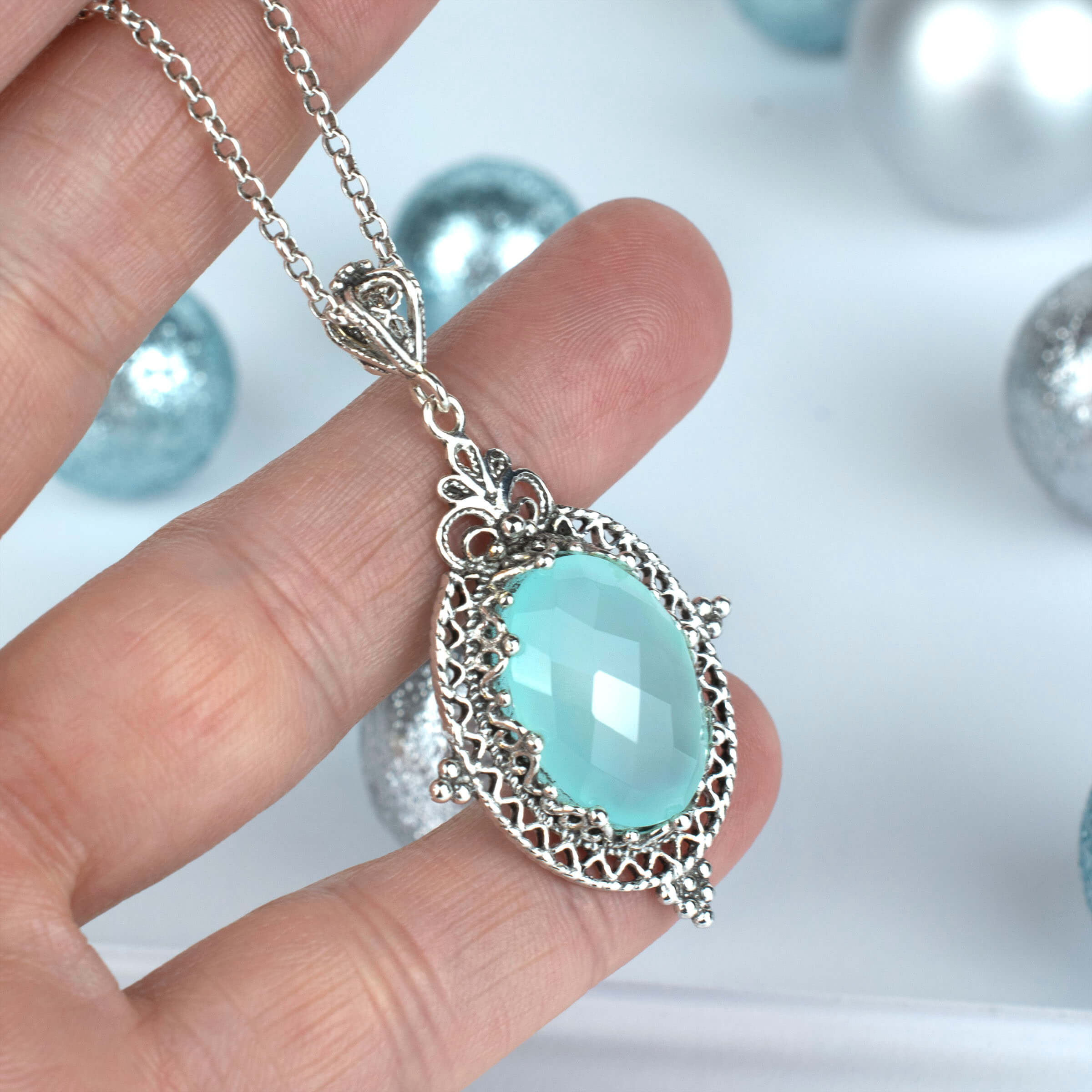 Elegant silver oval pendant featuring Aqua Chalcedony gemstone with intricate filigree design, perfect for women.