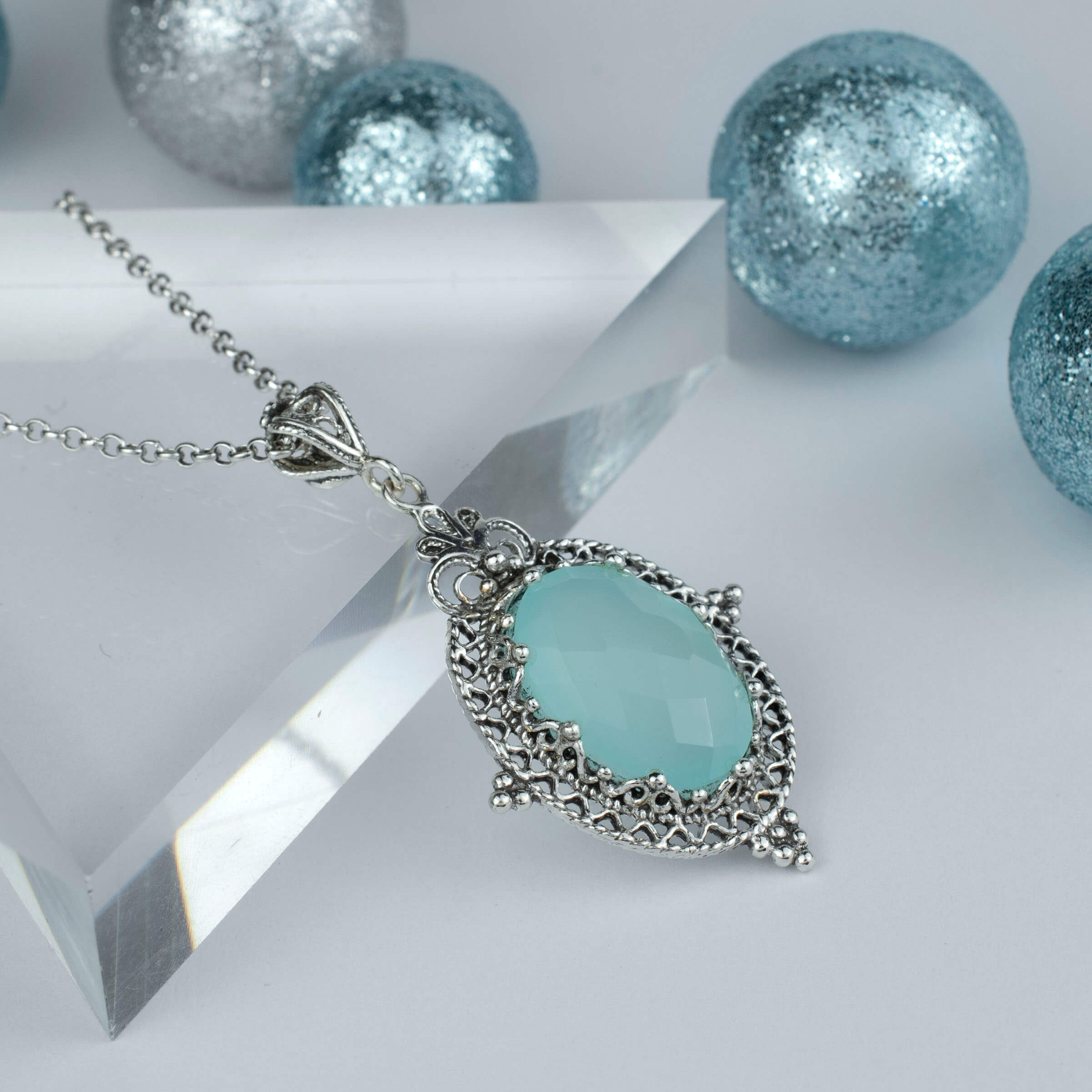 Elegant silver oval pendant featuring Aqua Chalcedony gemstone with intricate filigree design, perfect for women.