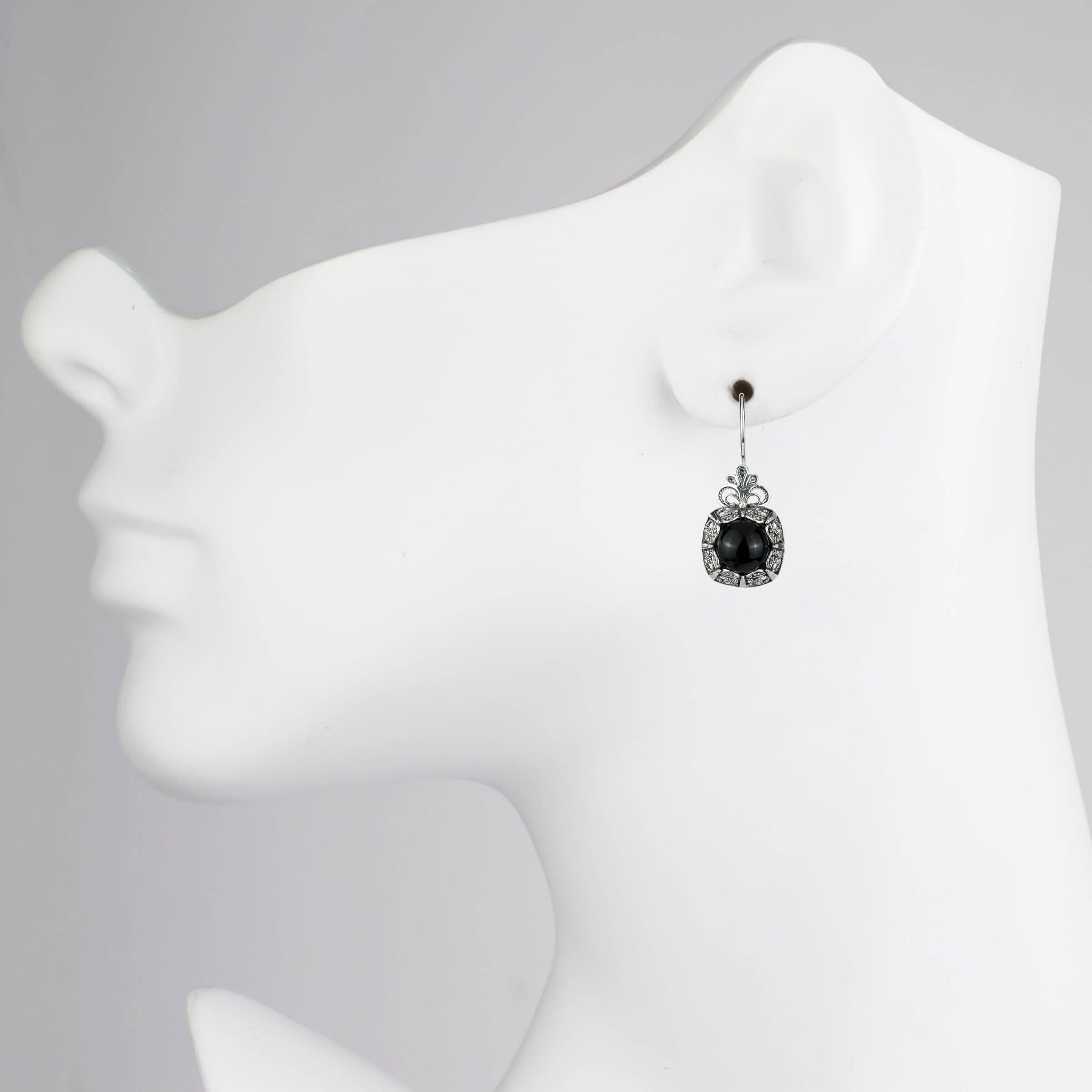 Elegant handmade silver drop earrings featuring intricate filigree design and black onyx gemstone.