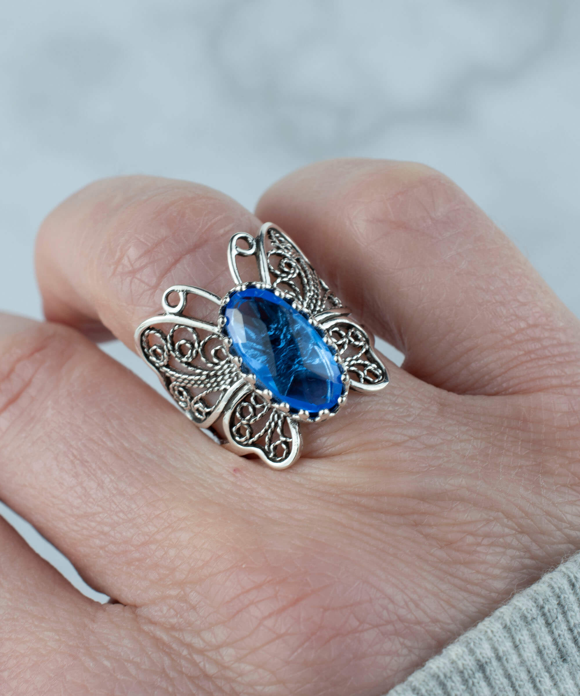 Sterling silver butterfly ring featuring a blue quartz gemstone with intricate filigree design.
