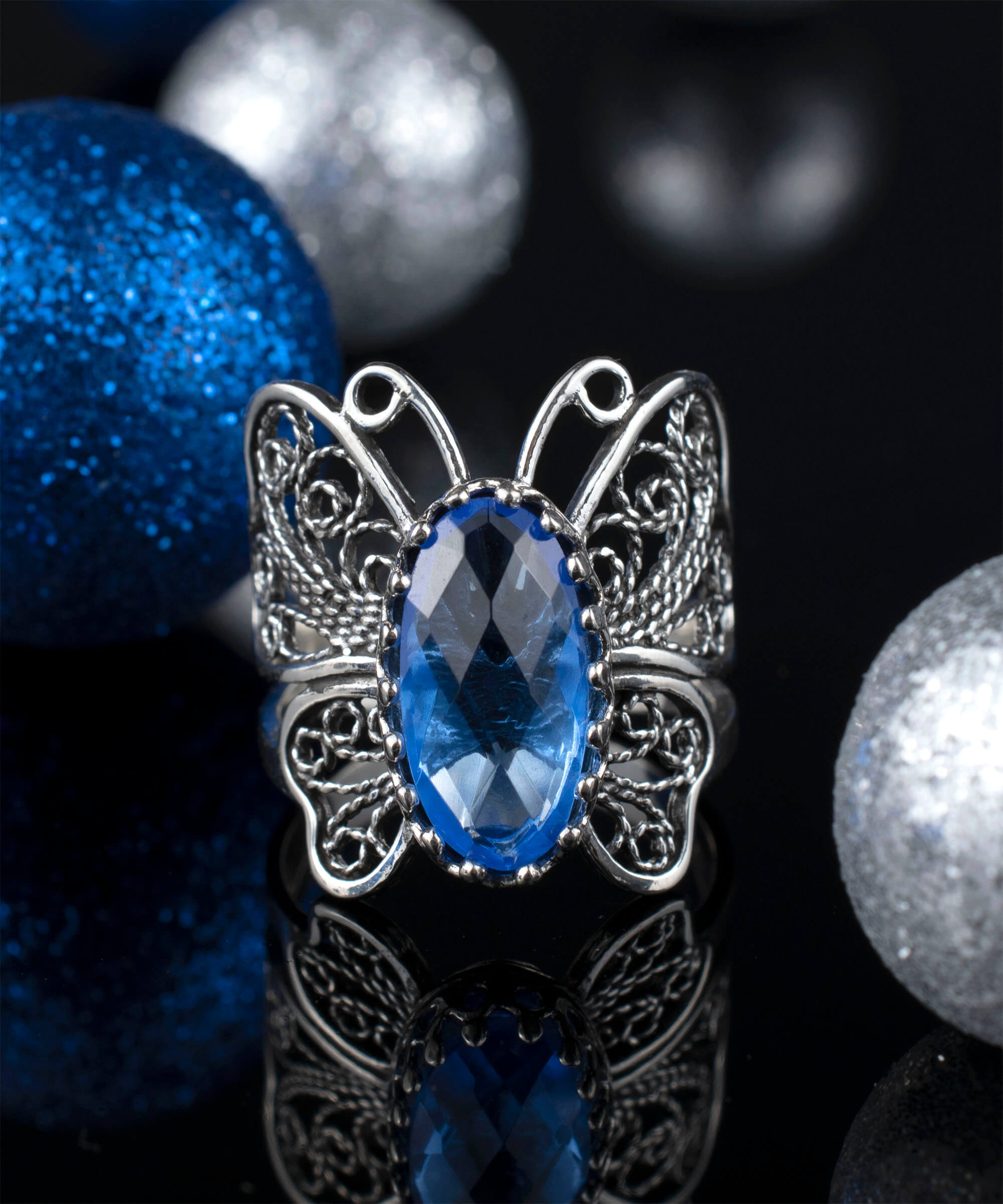Sterling silver butterfly ring featuring a blue quartz gemstone with intricate filigree design.