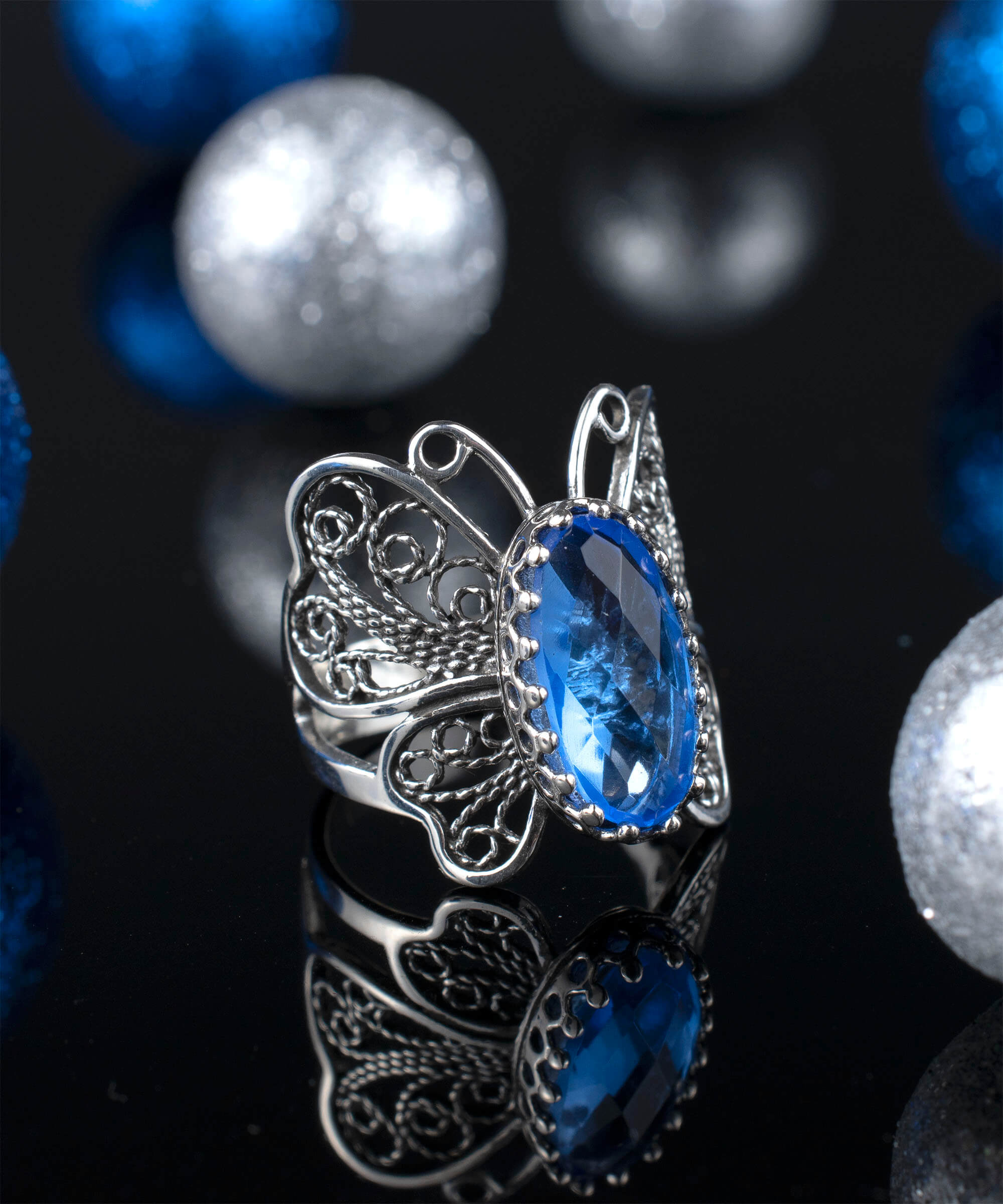 Sterling silver butterfly ring featuring a blue quartz gemstone with intricate filigree design.