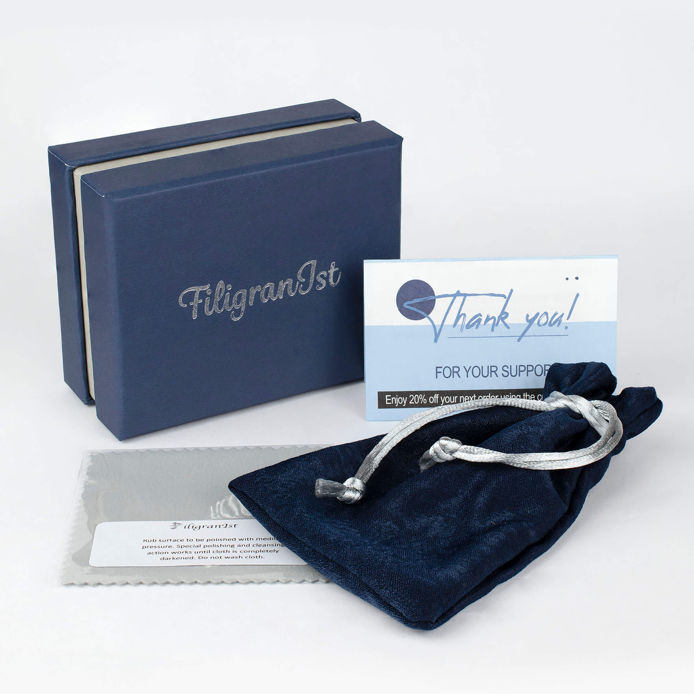 A stunning sterling silver bracelet featuring filigree art and a blue quartz gemstone in a butterfly design, elegantly displayed on a soft surface.