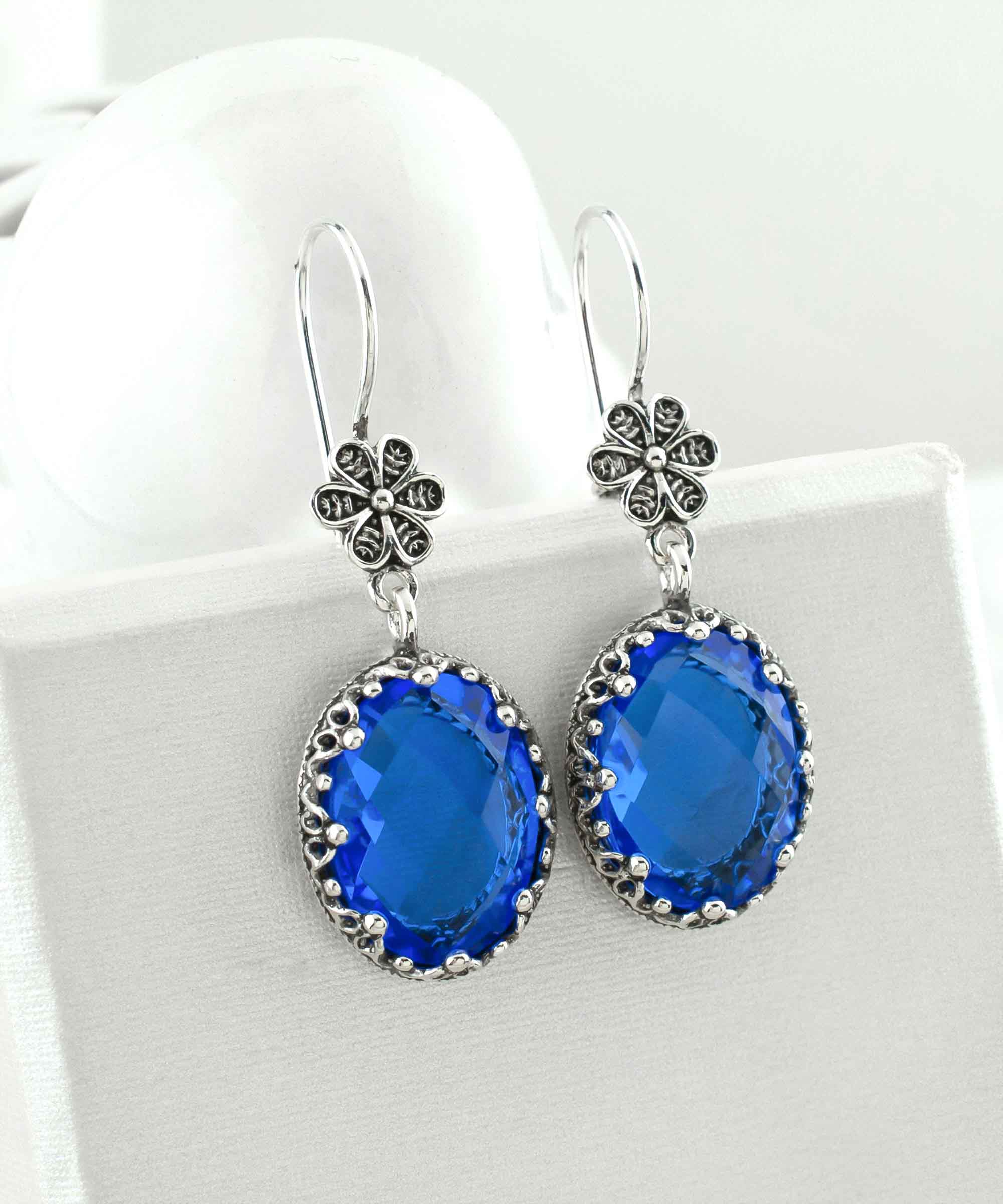 Elegant Filigree Art Blue Quartz Gemstone Dangle Earrings in 925 sterling silver, showcasing intricate designs and vibrant gemstones.