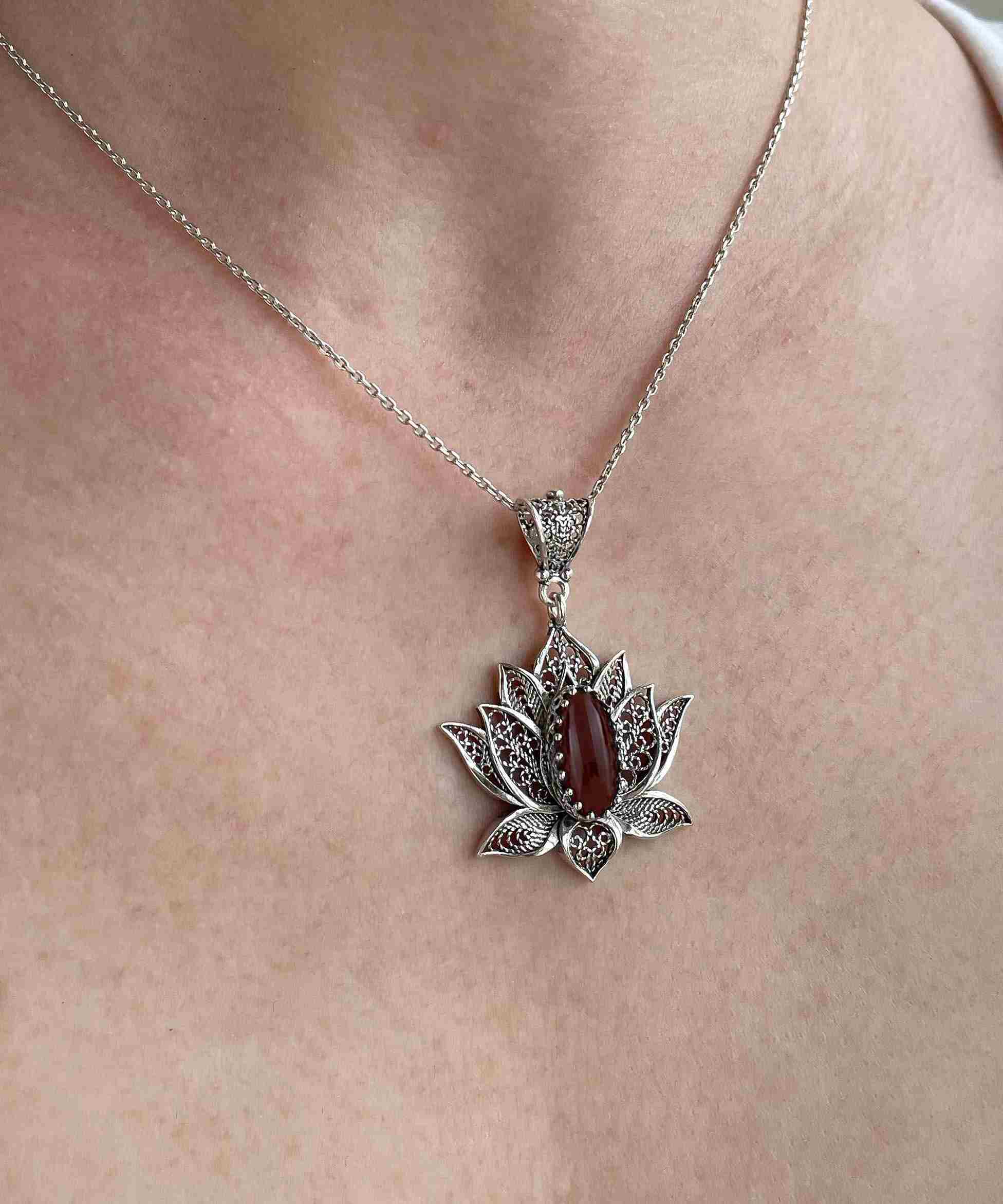 Elegant 925 Sterling Silver necklace featuring a filigree lotus flower design with a vibrant Carnelian gemstone.