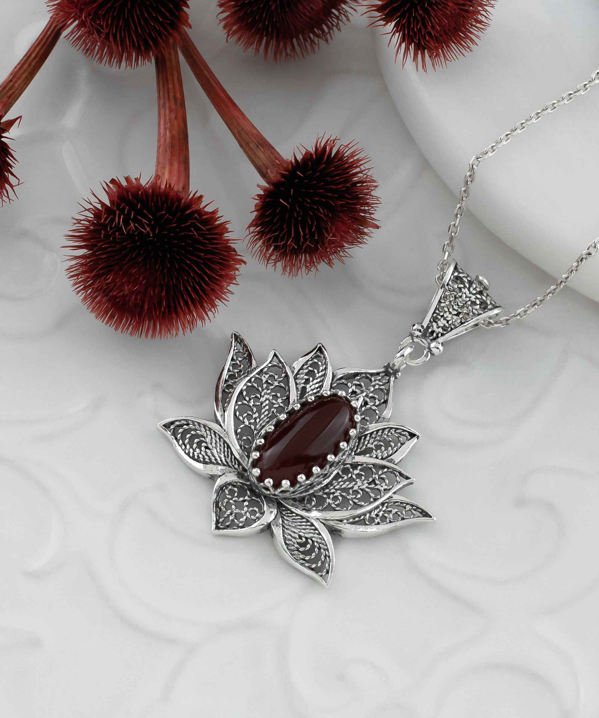 Elegant 925 Sterling Silver necklace featuring a filigree lotus flower design with a vibrant Carnelian gemstone.