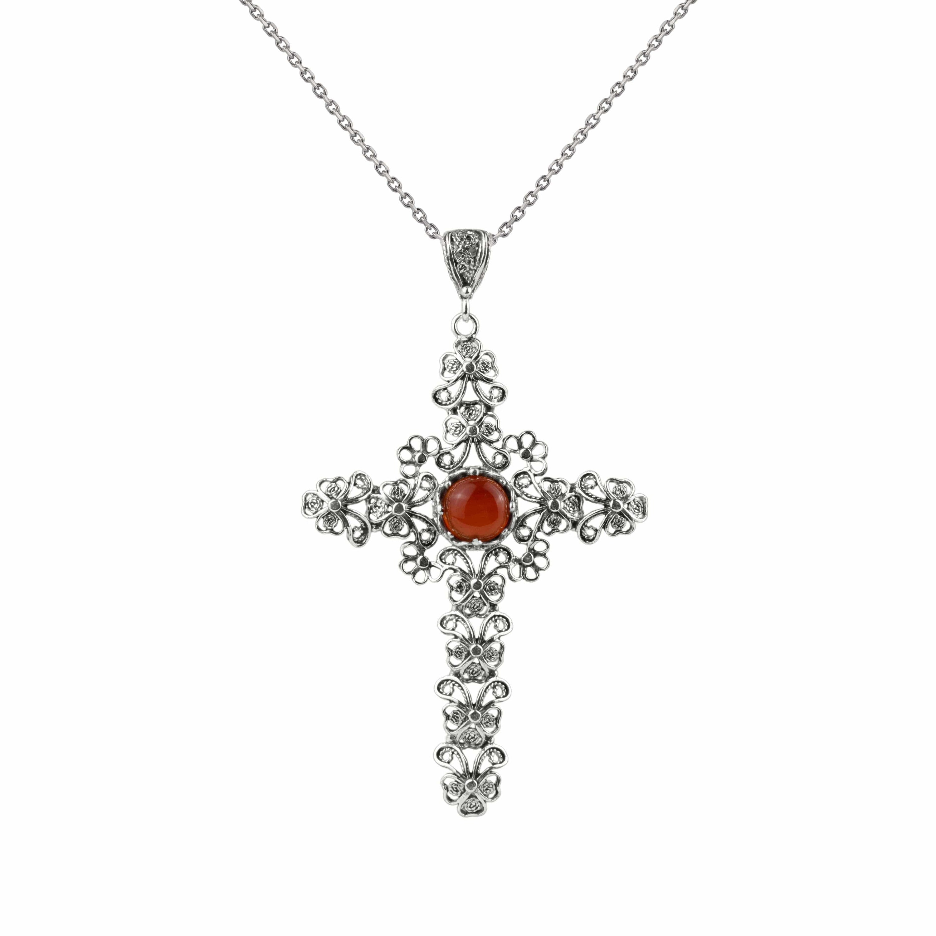 Elegant silver cross pendant featuring intricate filigree art and a vibrant carnelian gemstone, perfect for women.