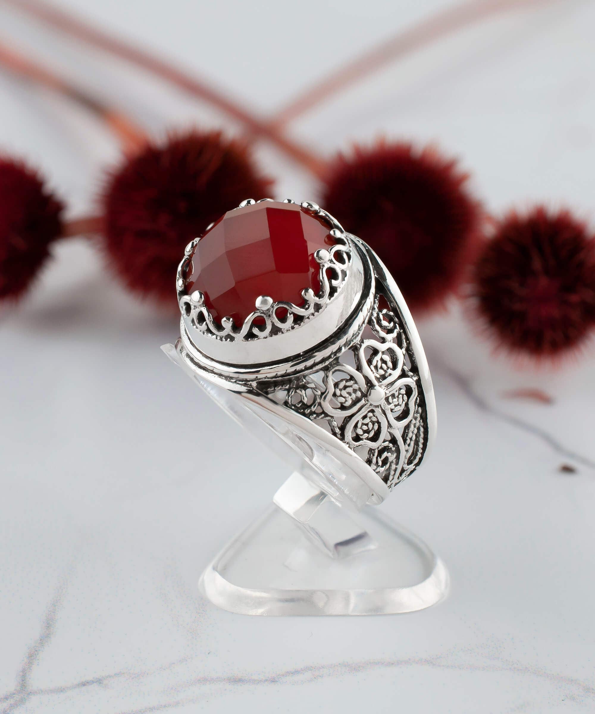 A stunning sterling silver filigree ring featuring a round, faceted rose-cut carnelian gemstone, elegantly designed for women.
