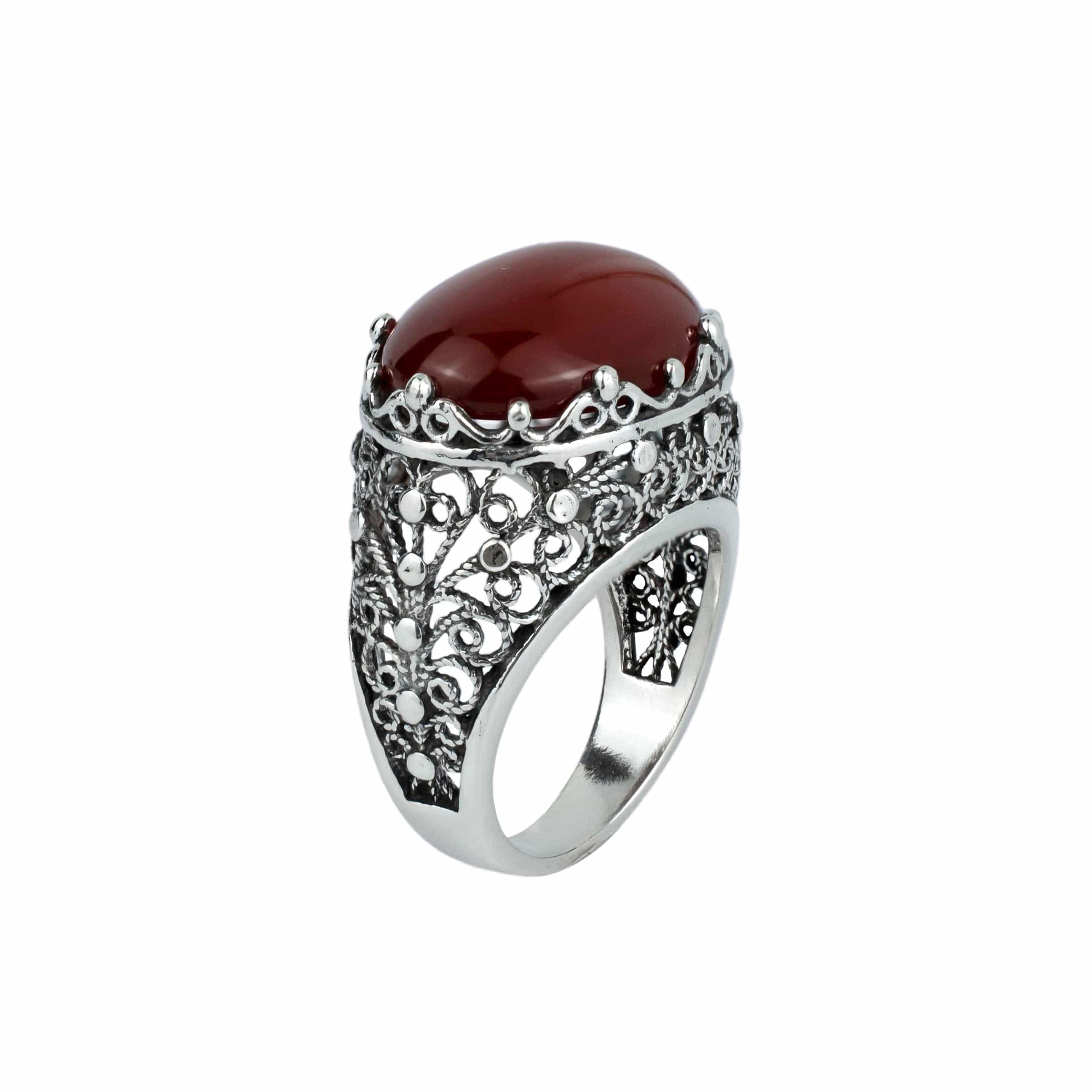 A stunning handmade silver dome statement ring featuring a vibrant carnelian gemstone set in intricate filigree design, showcasing exquisite craftsmanship.