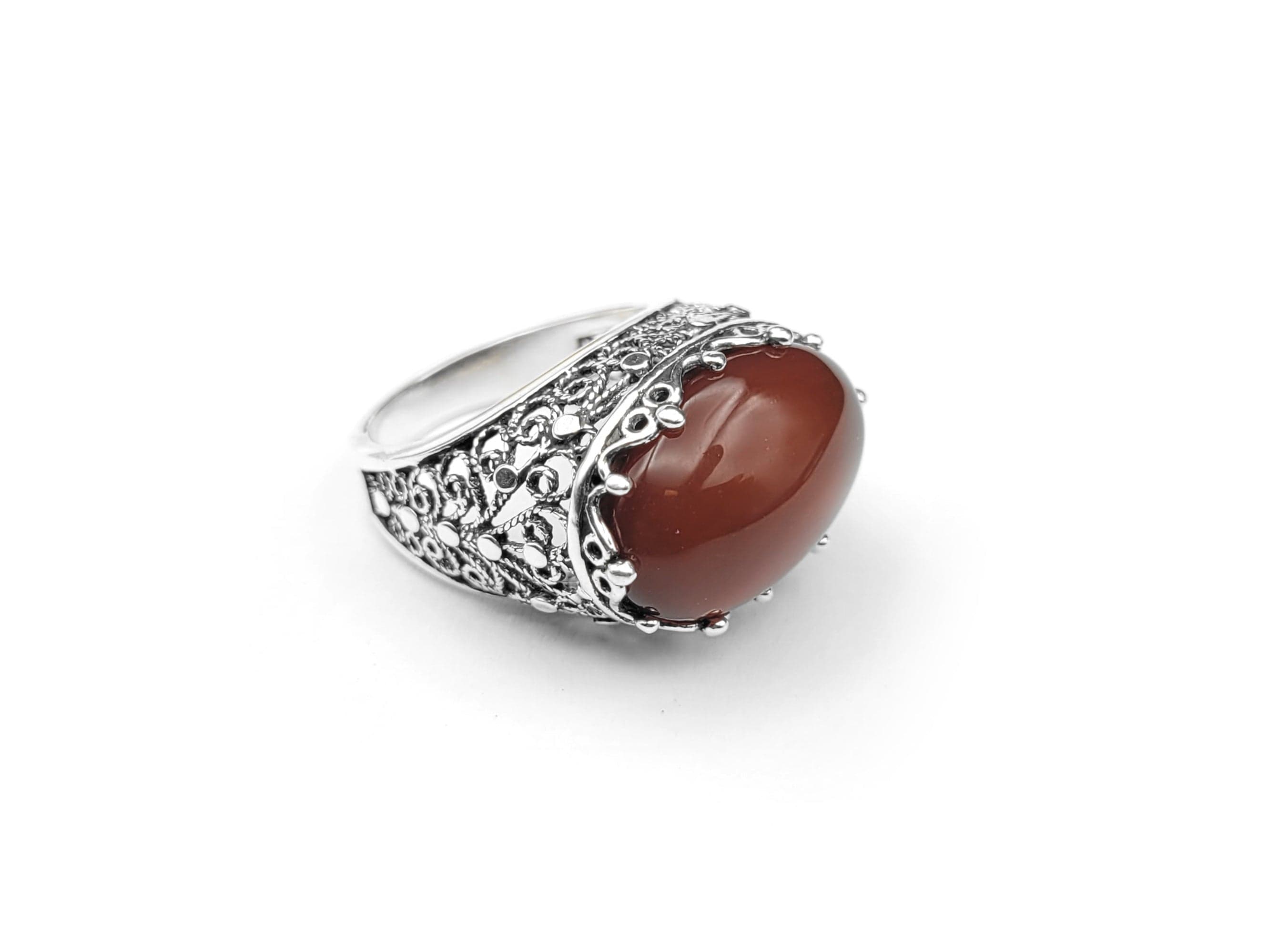 A stunning handmade silver dome statement ring featuring a vibrant carnelian gemstone set in intricate filigree design, showcasing exquisite craftsmanship.