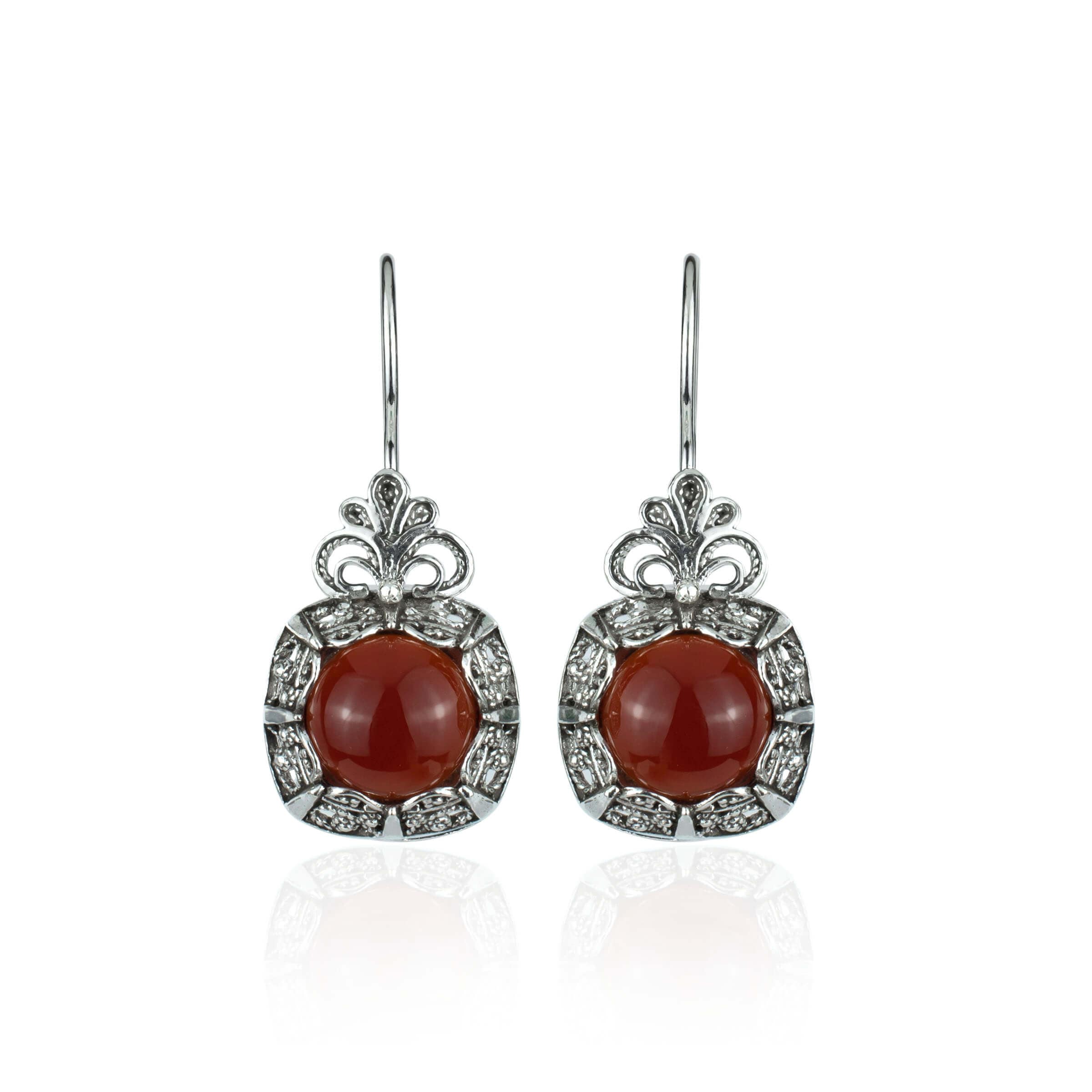Elegant handmade silver drop earrings featuring intricate filigree design and a vibrant carnelian gemstone.