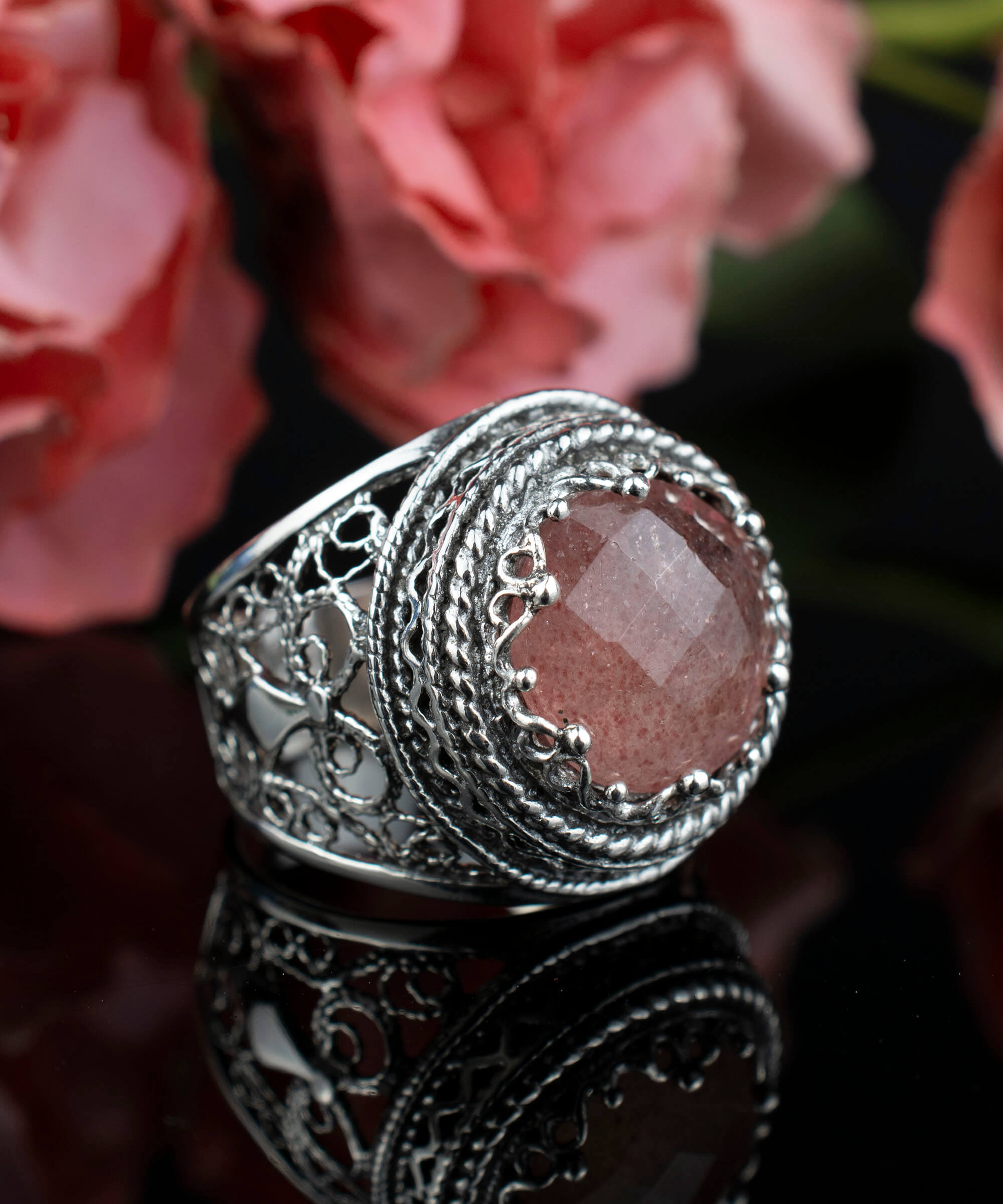 A stunning sterling silver bold ring featuring a cherry quartz gemstone with intricate filigree art design, showcasing a blend of traditional and modern craftsmanship.