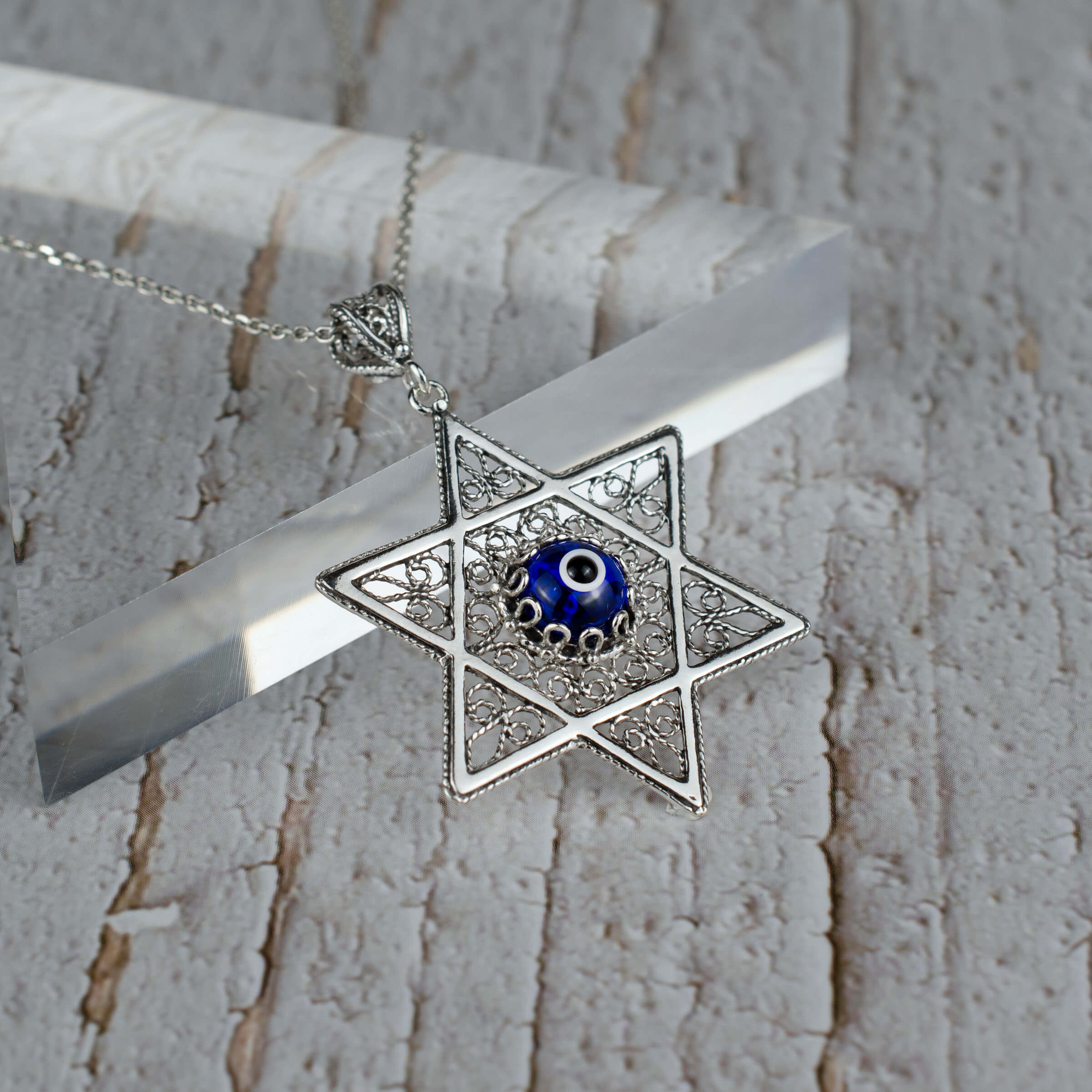 Sterling silver filigree art pendant featuring an Evil Eye stone and Star of David design, elegantly crafted for women.