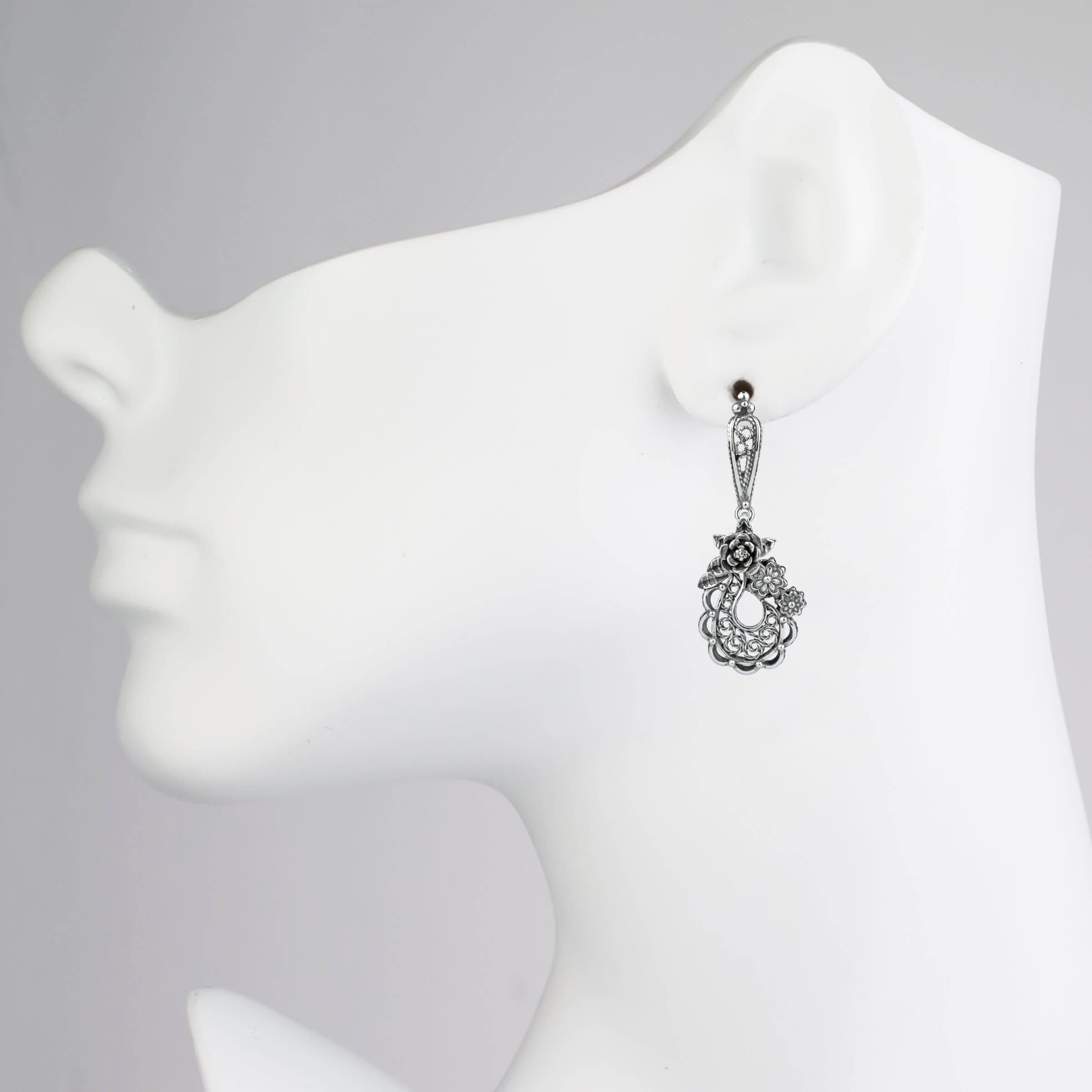Handmade sterling silver dangle earrings featuring a filigree bucket of flowers design, showcasing intricate detailing and an antique-inspired finish.