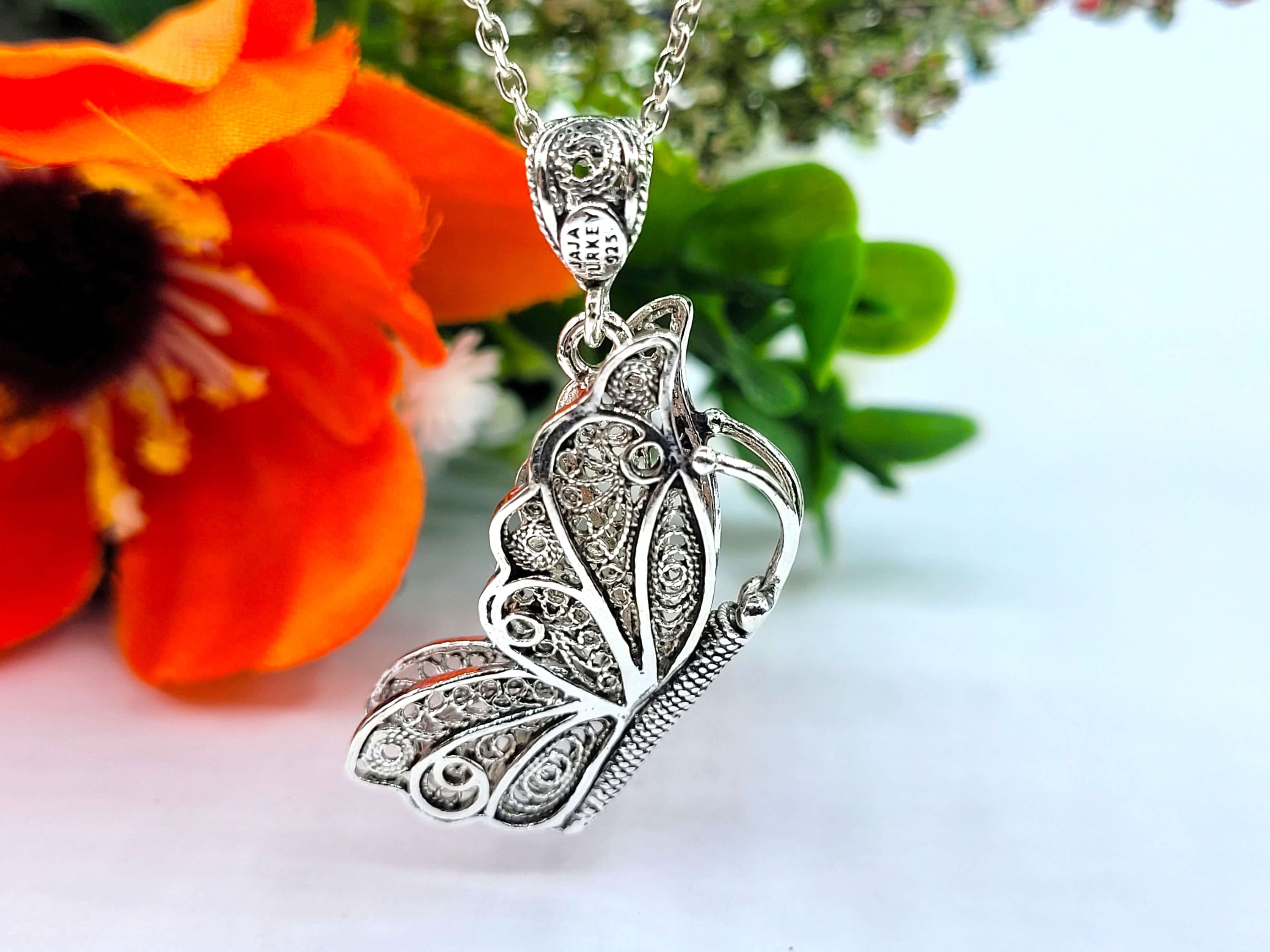Sterling silver filigree butterfly pendant necklace with an 18-inch chain and extender, showcasing intricate craftsmanship.