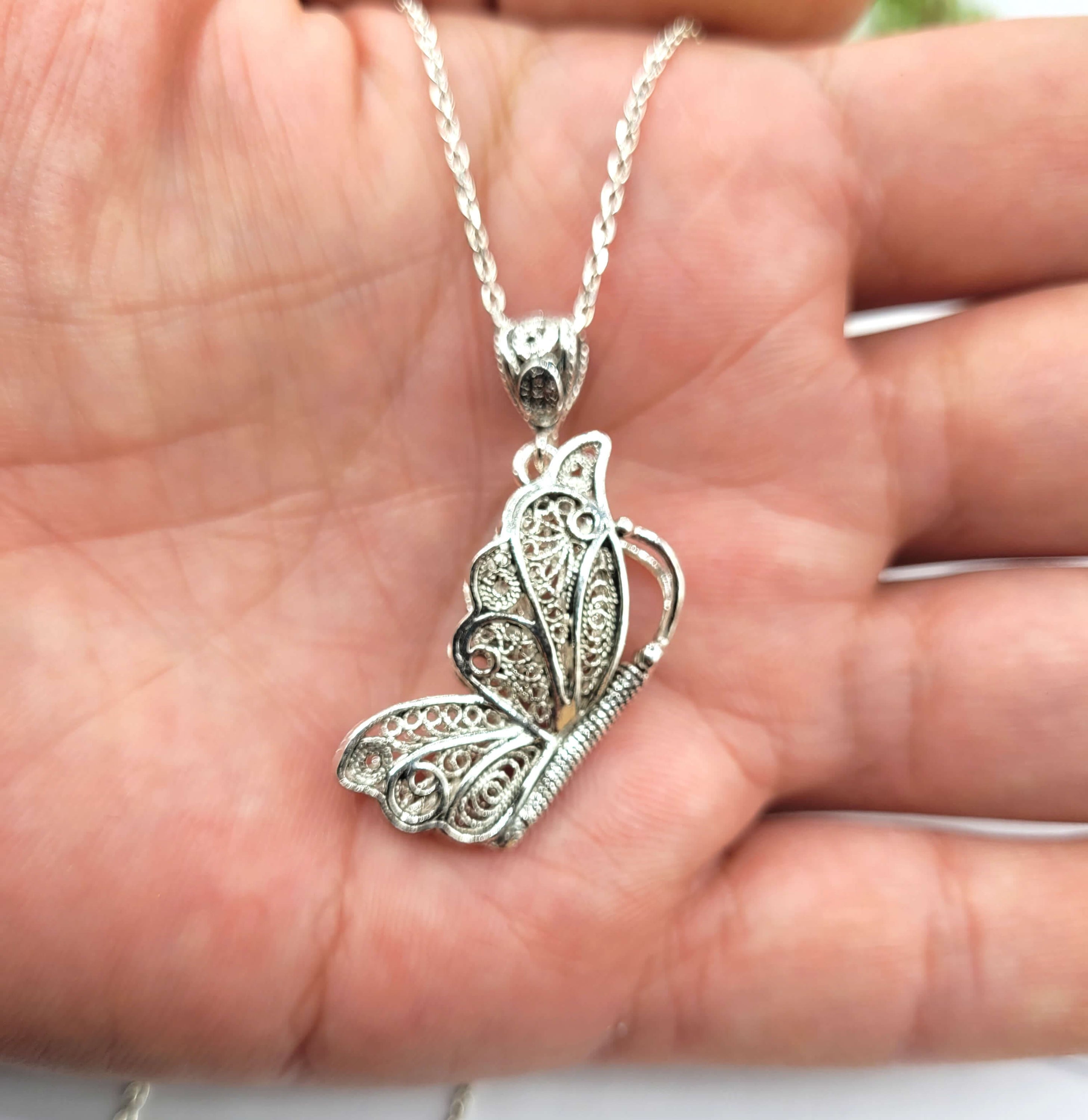 Sterling silver filigree butterfly pendant necklace with an 18-inch chain and extender, showcasing intricate craftsmanship.