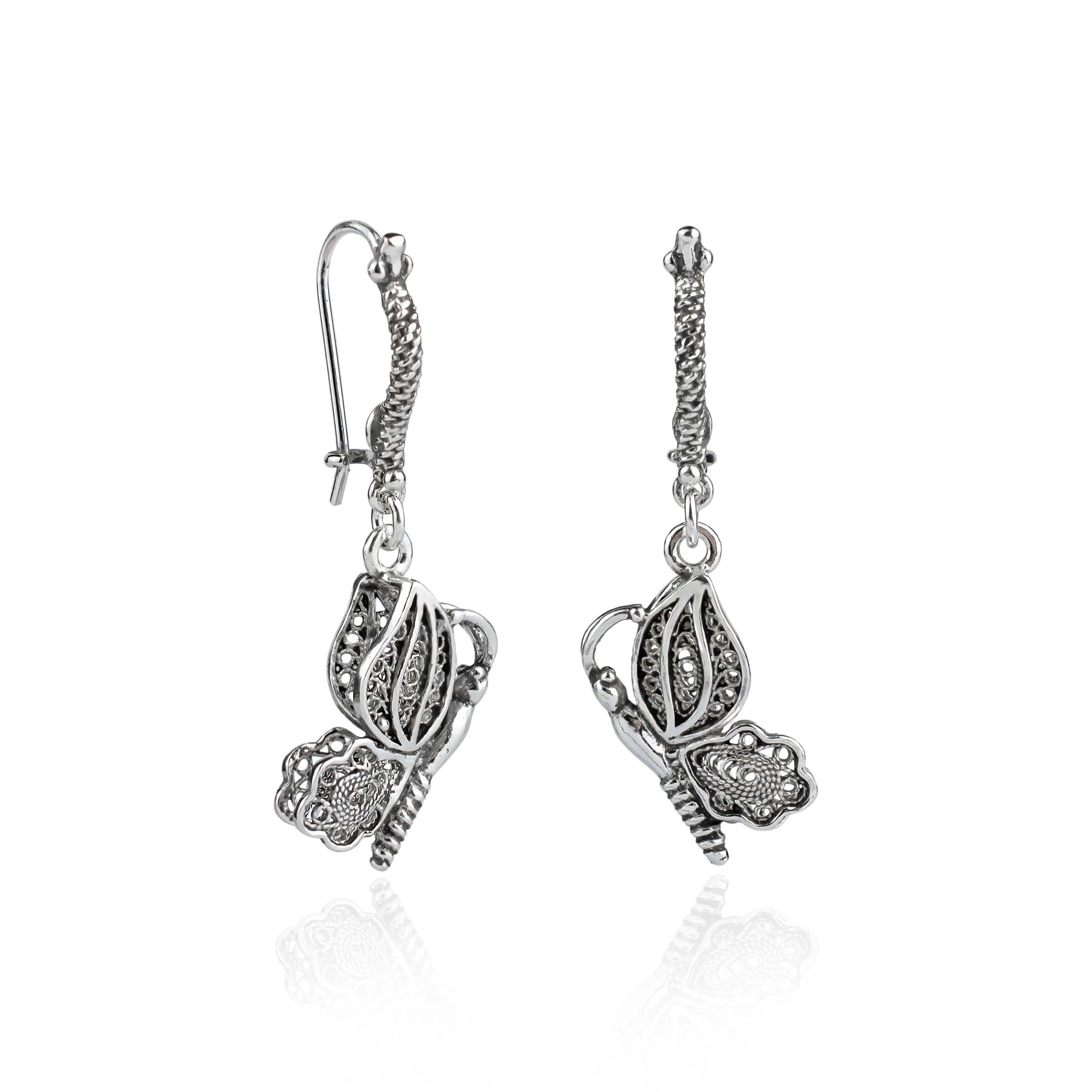 Elegant silver dangle drop earrings featuring a filigree butterfly design, handcrafted from 925 sterling silver.