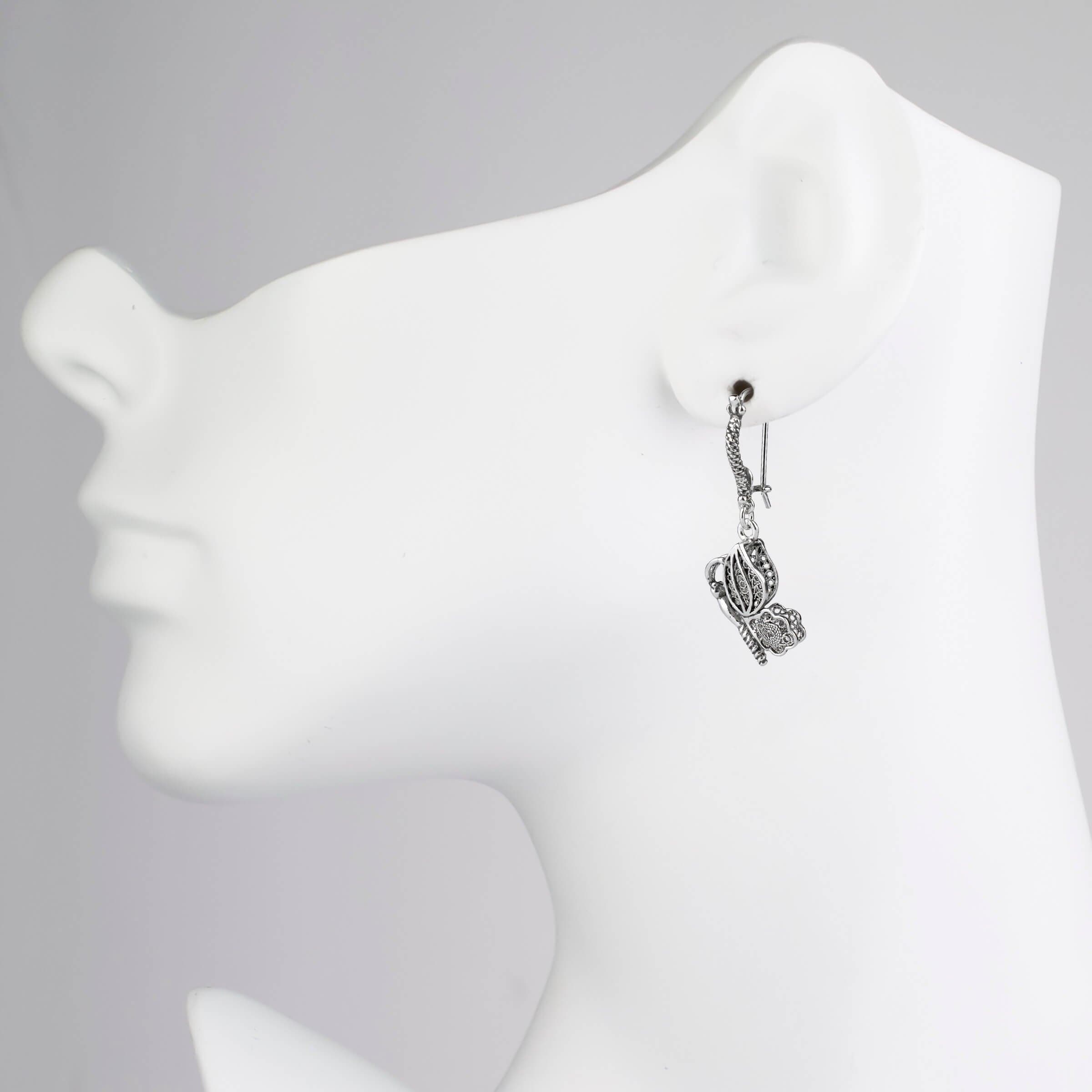 Elegant silver dangle drop earrings featuring a filigree butterfly design, handcrafted from 925 sterling silver.